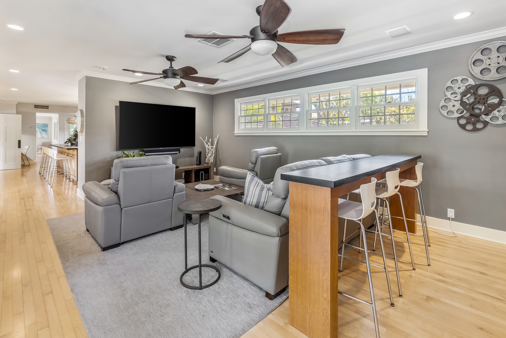Honolulu Vacation Rentals, Moana Lani - Main House - Movie night on the big screen, with bar stools at the counter for anyone on snack duty.