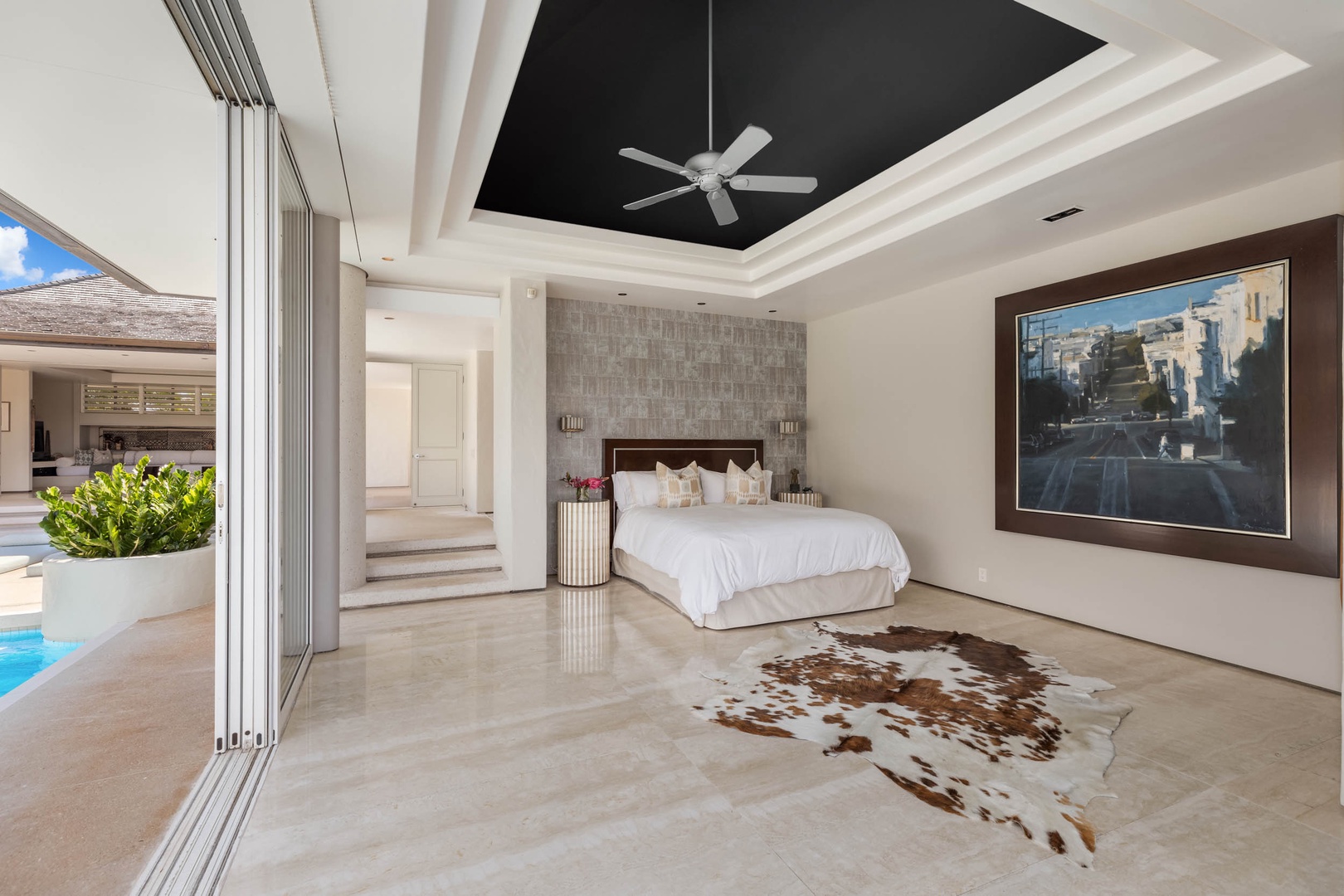 Honolulu Vacation Rentals, Sky Ridge House - The luxurious white bedding contrasts beautifully with a natural-toned cowhide rug, setting the tone for opulent relaxation.
