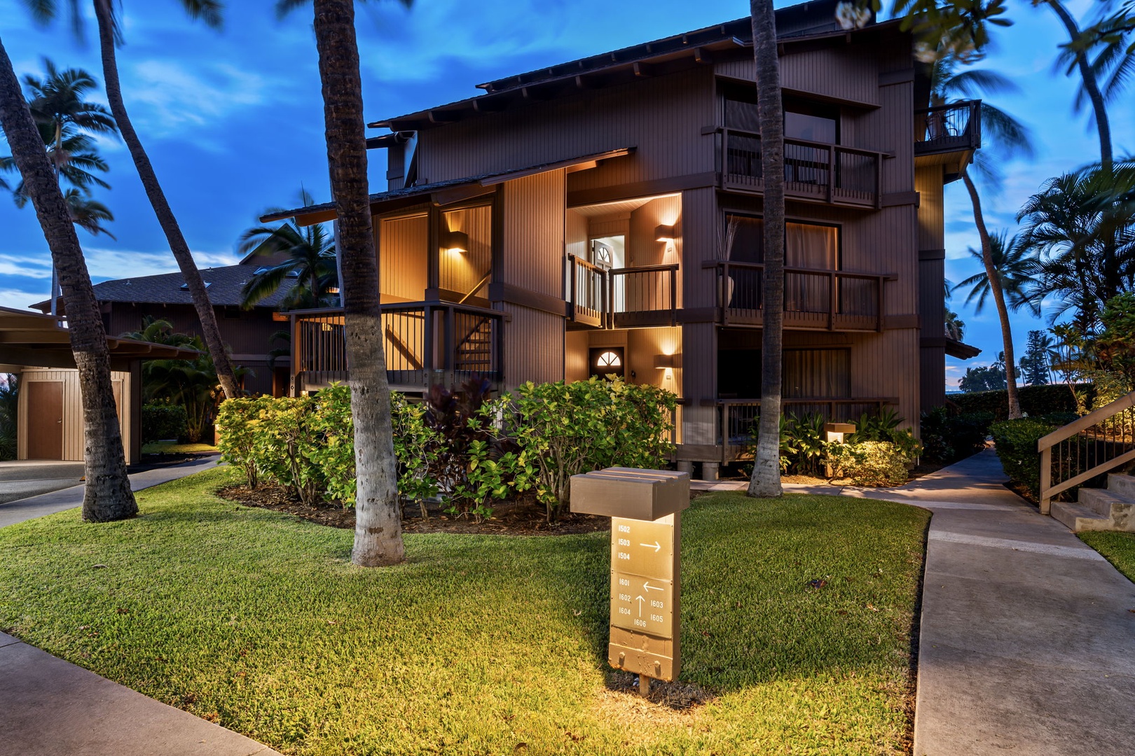 Kailua Kona Vacation Rentals, Kanaloa at Kona 1606 - Evening settles over the low wood-frame buildings and the paths winding between them.