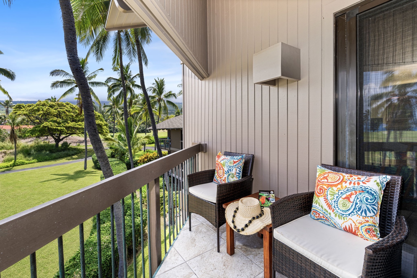 Kailua Kona Vacation Rentals, Kanaloa at Kona 1606 - A quiet corner lanai with two chairs and a view into the palms.