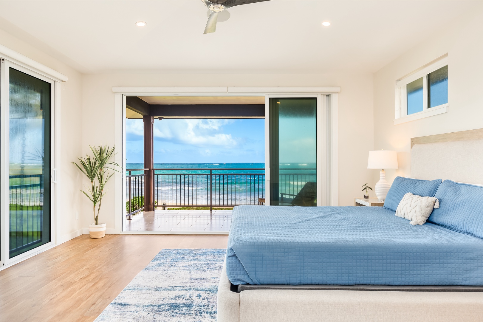 Laie Vacation Rentals, Majestic Mahakea Oceanfront Oasis - Primary suite with sliding doors that open to breathtaking beach views and fresh ocean breezes.