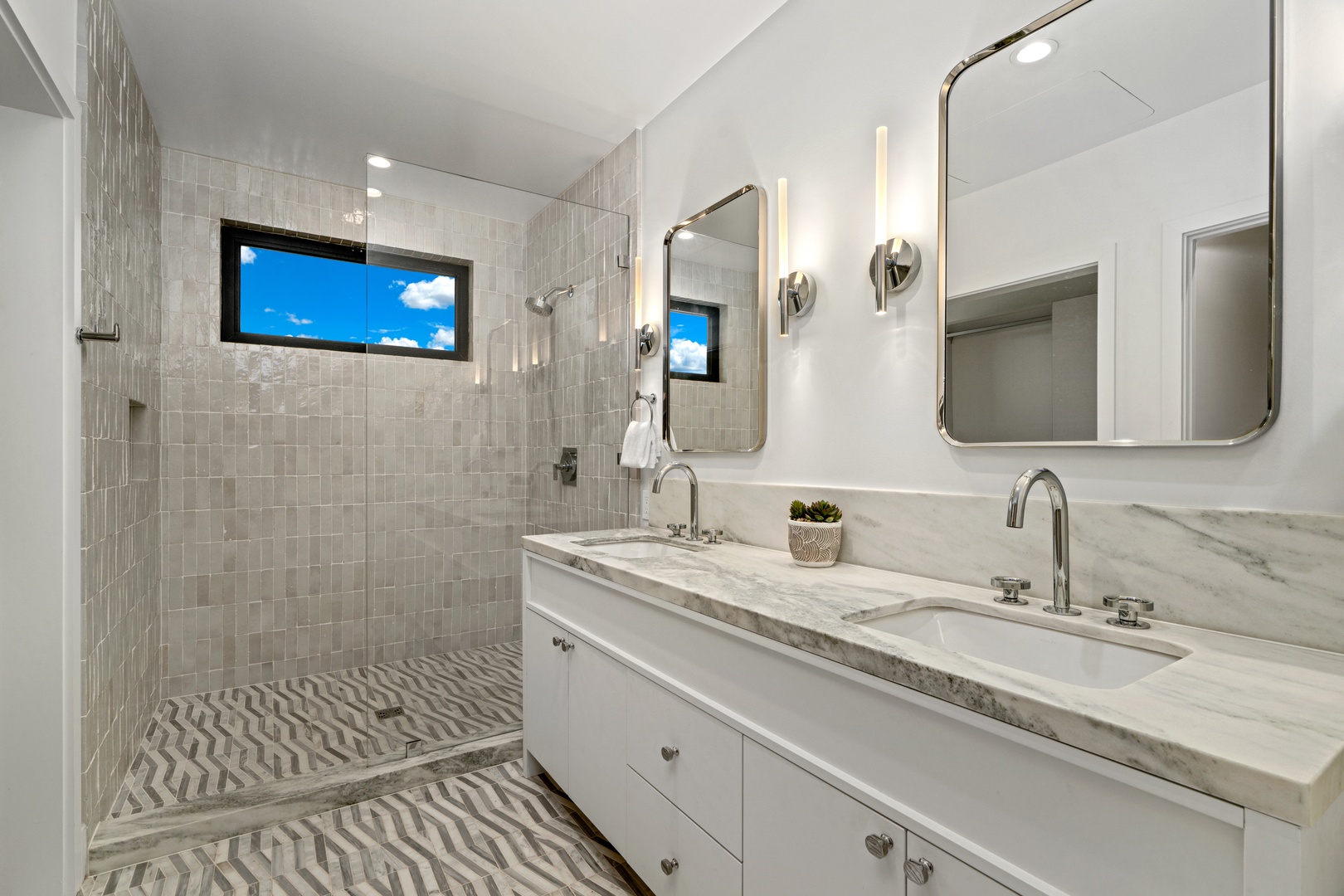 Koloa Vacation Rentals, Hale Laule'a at Kukui'ula - Unwind in your spa-like bathroom with marble counters, modern fixtures, and a luxurious walk-in shower featuring natural light.