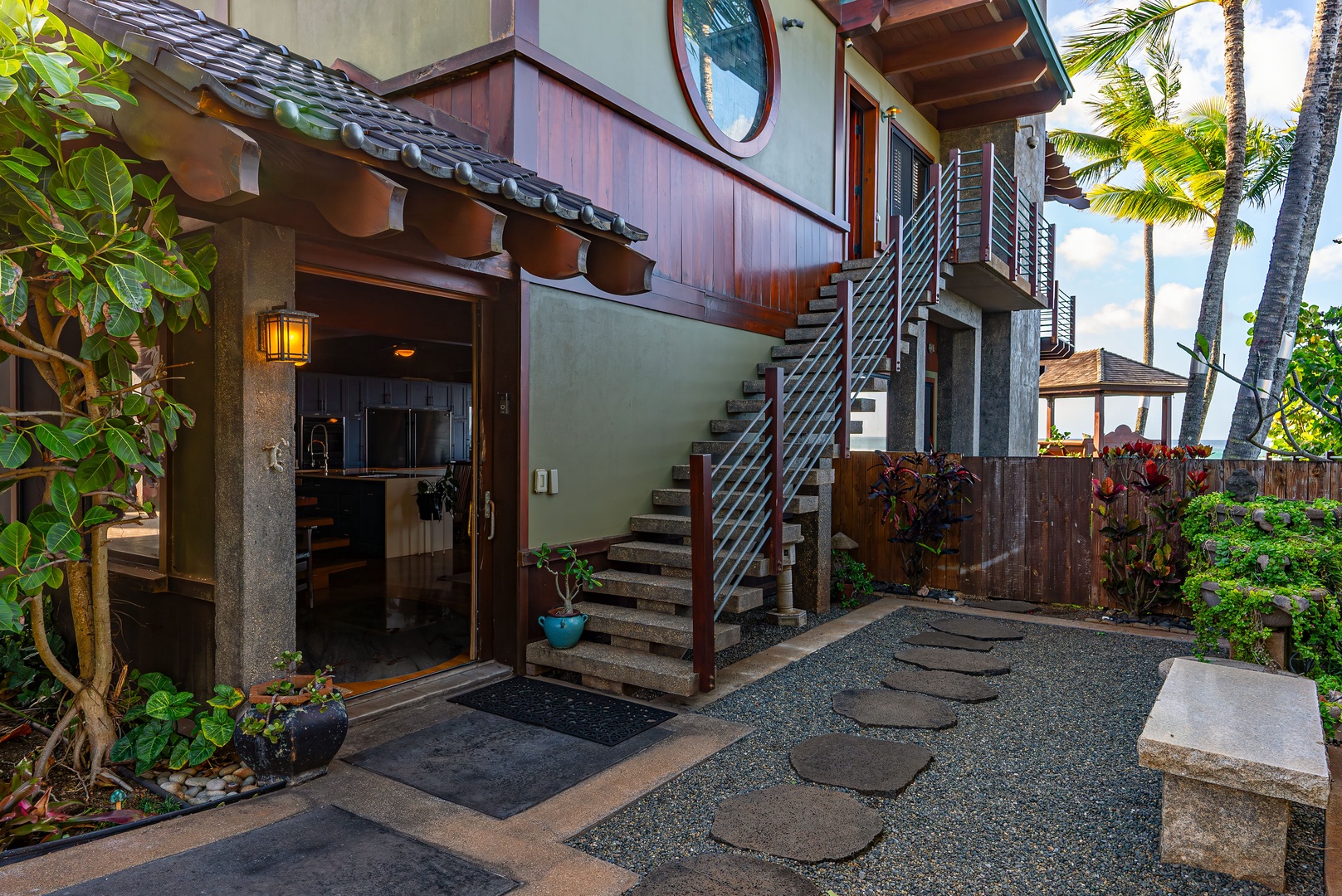 Haleiwa Vacation Rentals, Samurai House - Welcoming pathway leading to the main entry amidst vibrant greenery.