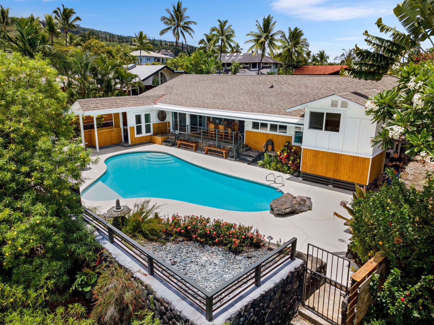 Kailua Kona Vacation Rentals, Manukai Hale - The home and pool spread across the lot, framed by mature palms.