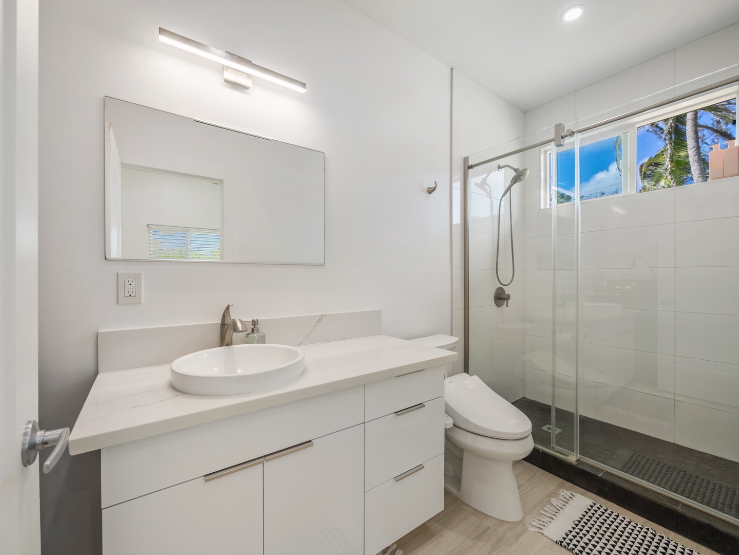 Haleiwa Vacation Rentals, Sunset Beach Island Retreat - The primary ensuite bathroom offers a sleek and minimalist design with its clean lines and white cabinetry