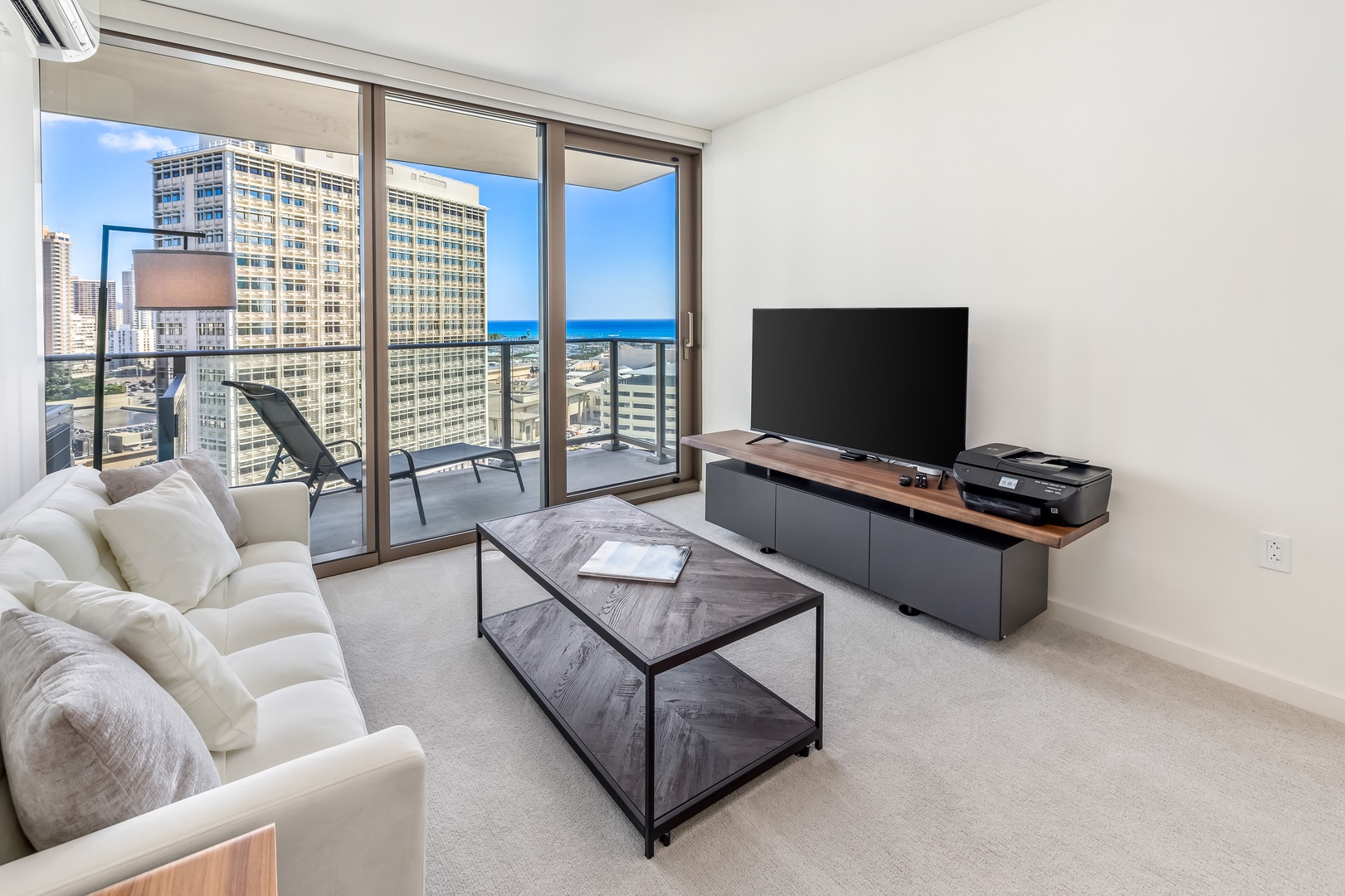 Honolulu Vacation Rentals, Sky Ala Moana #1701 - Cozy living area with a private lanai offering partial ocean and city views.