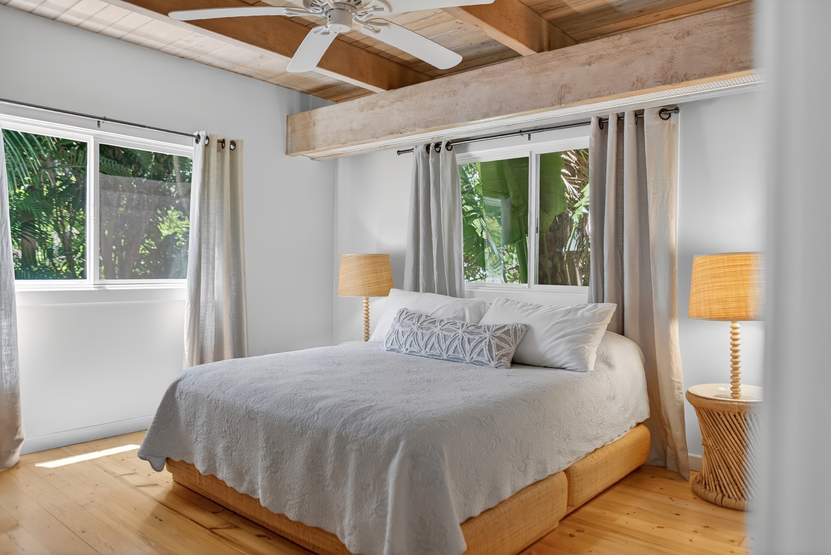 Haleiwa Vacation Rentals, Sunset Beach Hideaway - Drift off comfortably in the serene bedroom framed by tropical greenery outside.