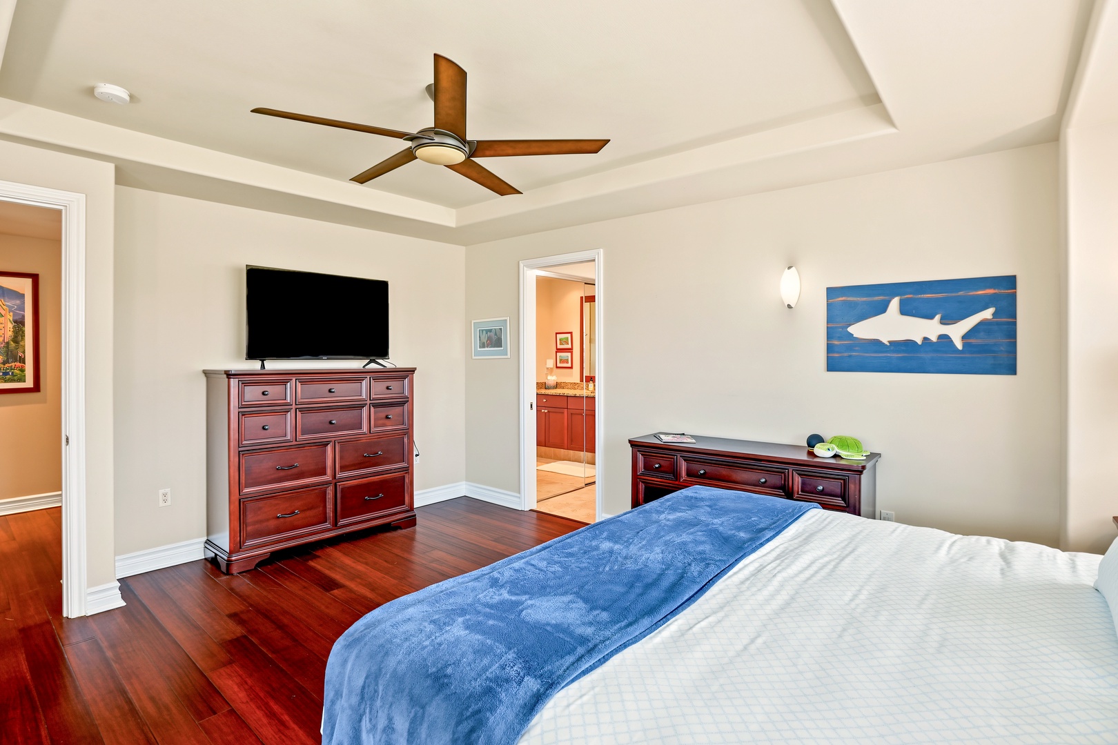 Princeville Vacation Rentals, Hale Hau'oli Moku - Catch a late show on the bedroom's own TV, tucked under a soft blue throw.