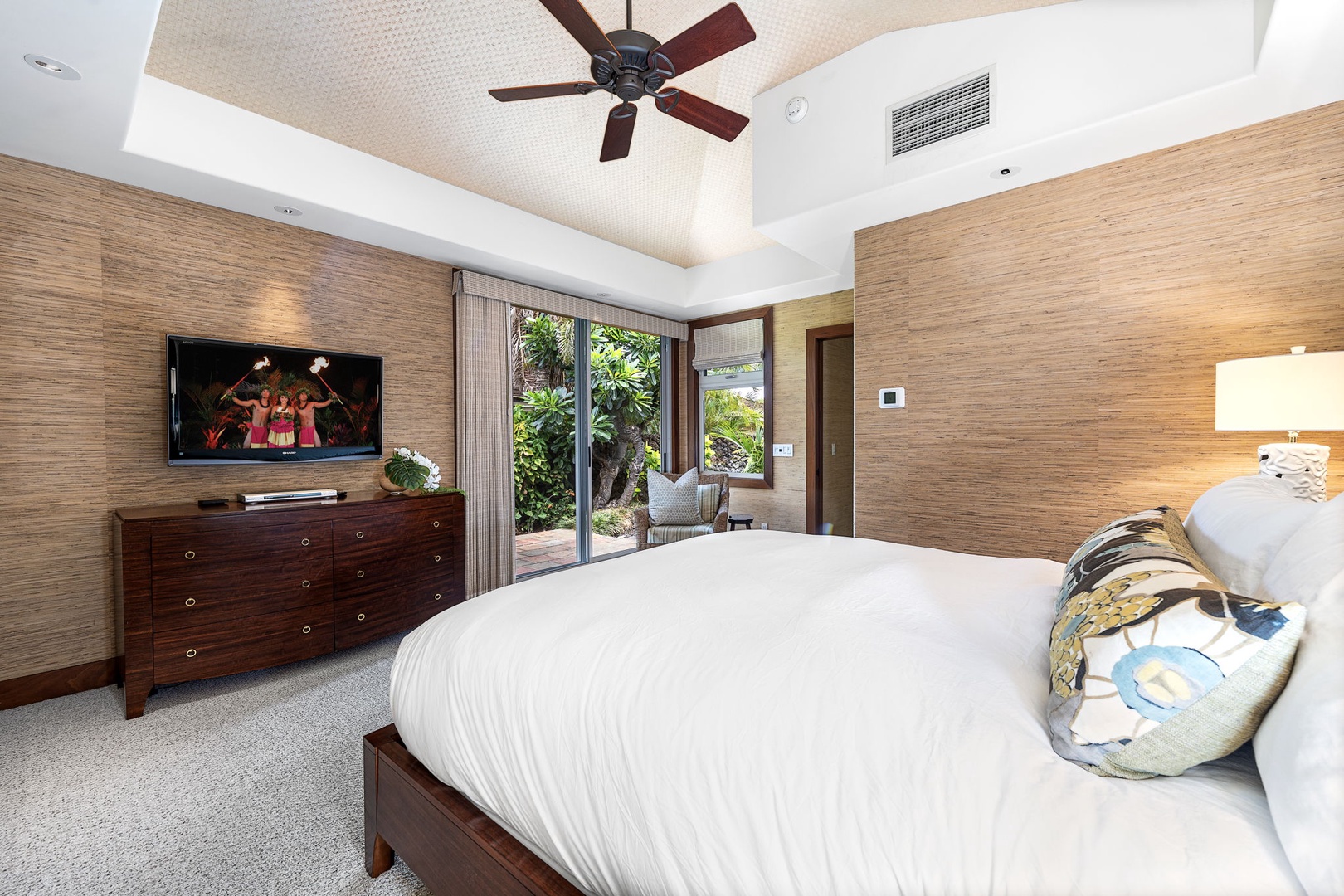 Kailua Kona Vacation Rentals, 3BD Pakui Street Estate (149) at Hualalai Resort - Step through the guest suite's doors to a private garden patio, the TV on the wall behind you.