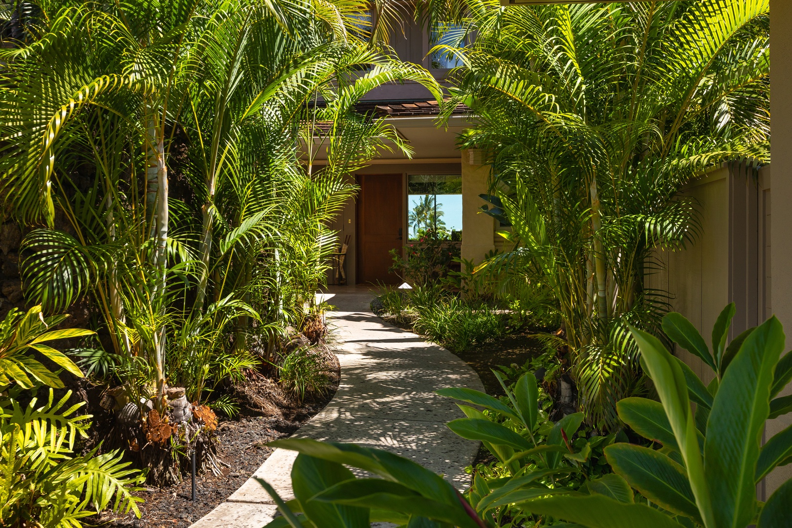 Kailua Kona Vacation Rentals, 2BD Hillside Villa (4102) at Hualalai Resort - Pathway through lush gardens leading to the villa’s front door.