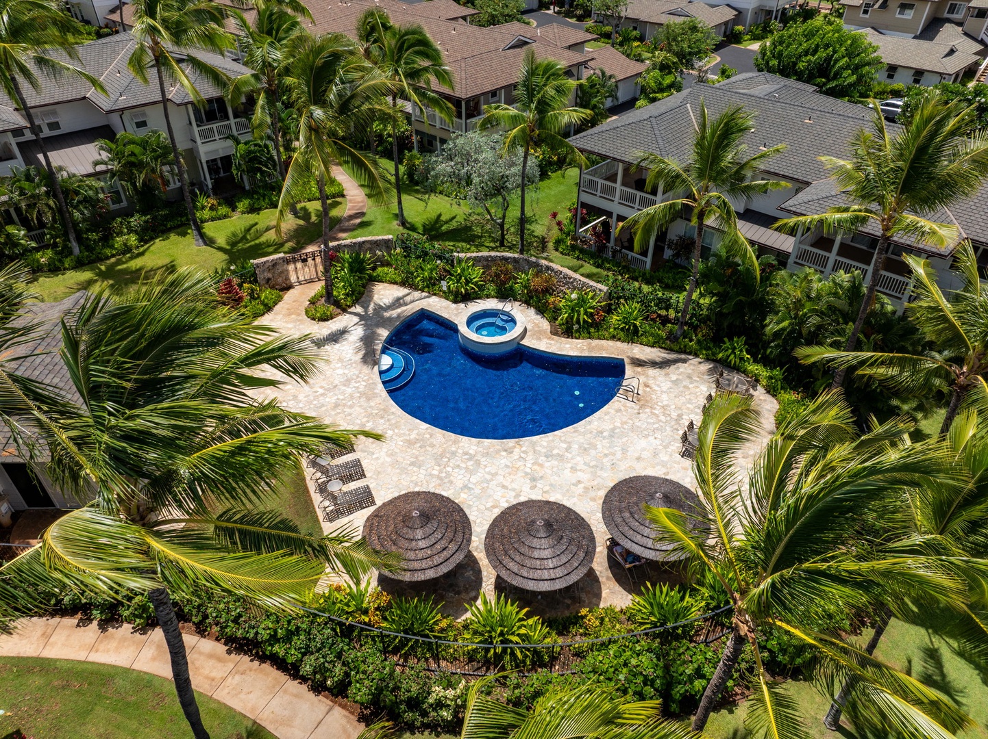 Kapolei Vacation Rentals, Coconut Plantation 1080-4 - The resort's lagoon-shaped pool and green grounds spread out from the air.