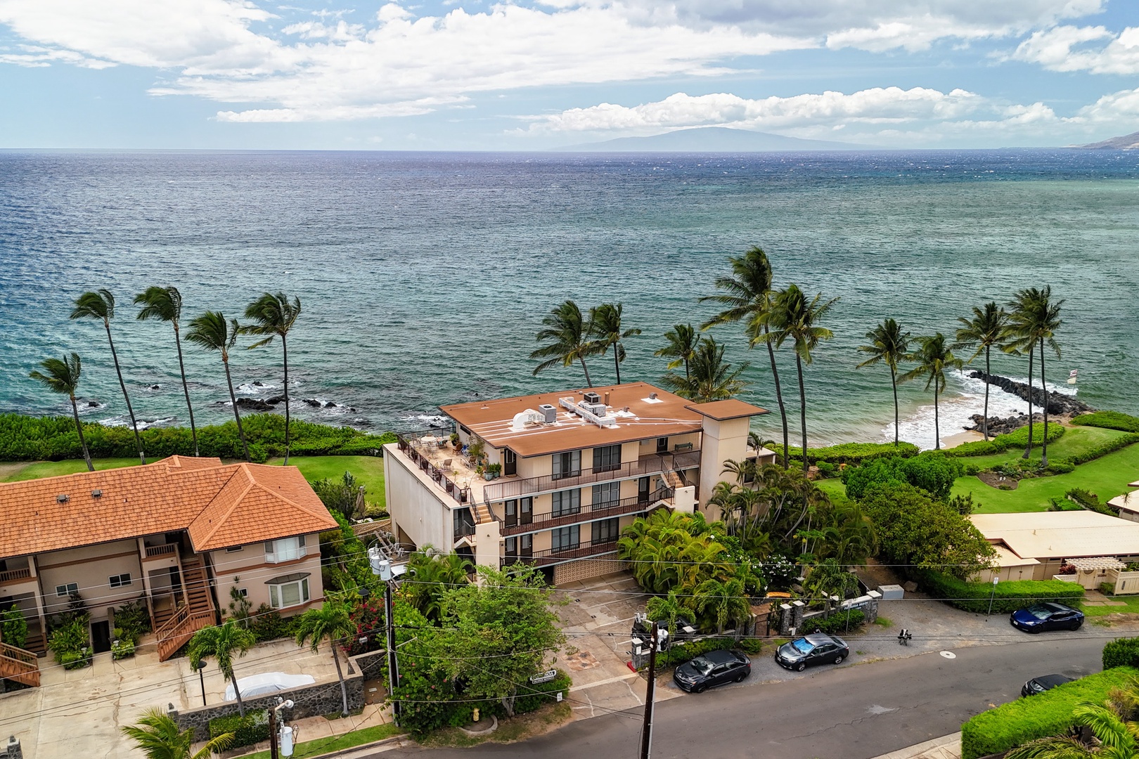Kihei Vacation Rentals, Punahoa Beach 205 - The building backs directly onto a cove where the sand curves in from open water.
