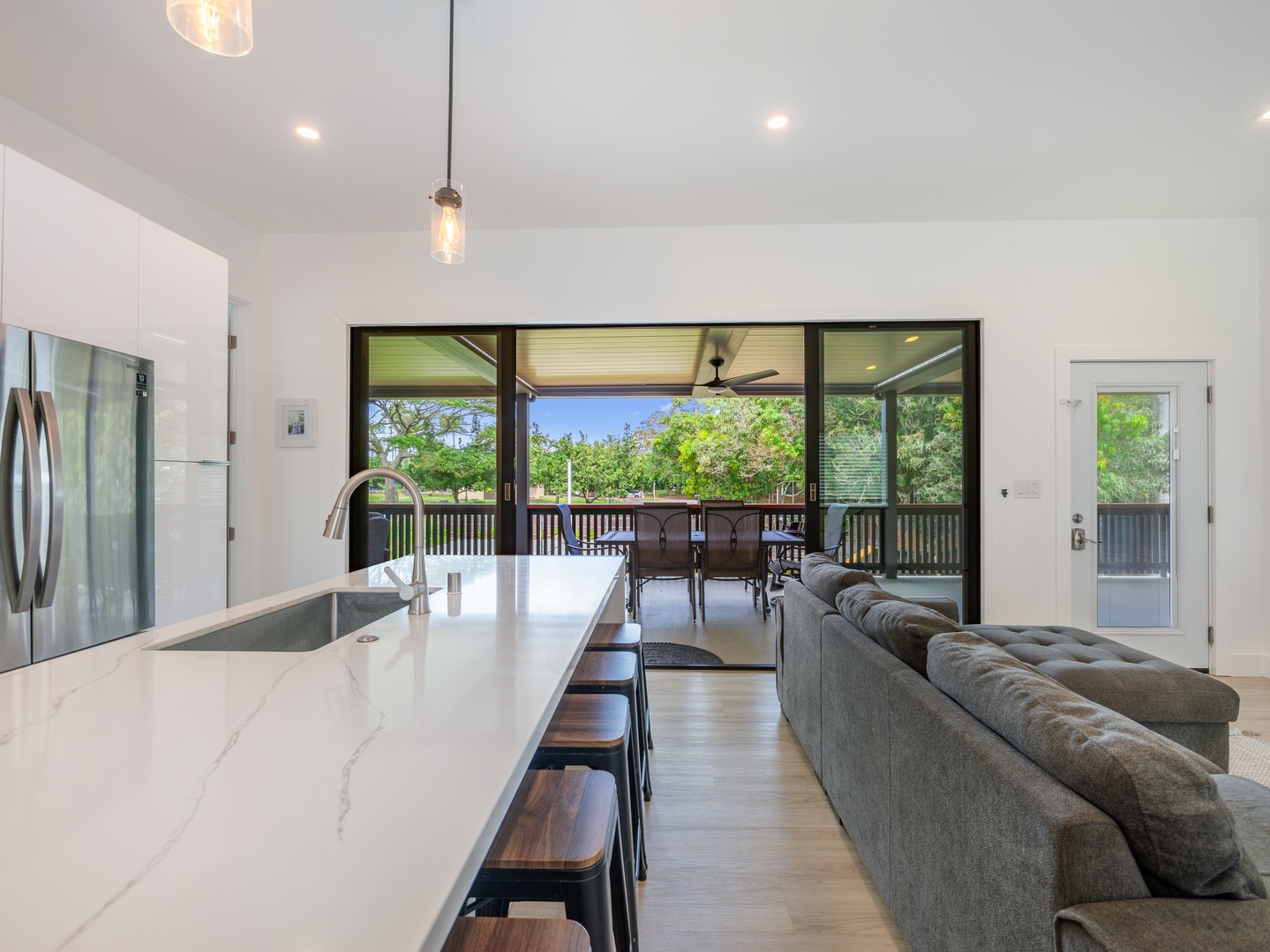 Haleiwa Vacation Rentals, Sunset Beach Island Retreat - This modern kitchen offers a large island with bar seating, perfect for casual dining or enjoying a morning coffee.