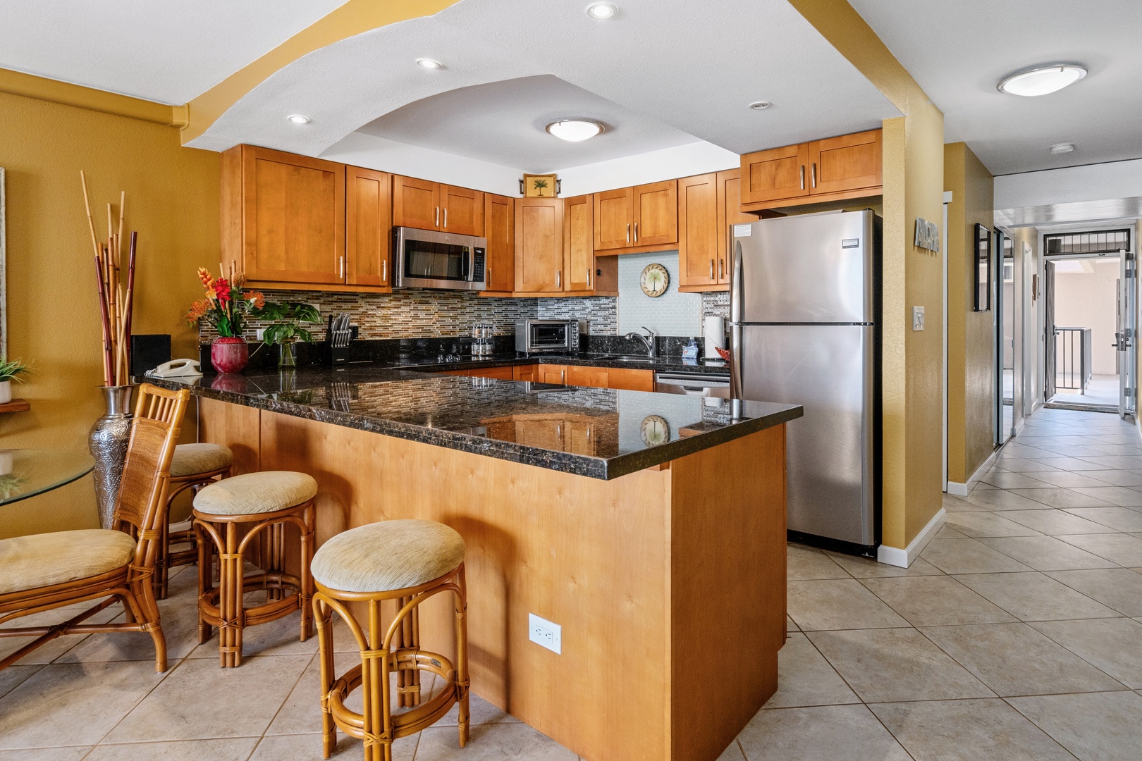 Kihei Vacation Rentals, Kamaole Sands 5310 - A quick bite at the counter, three bar stools pulled up before the day gets going.