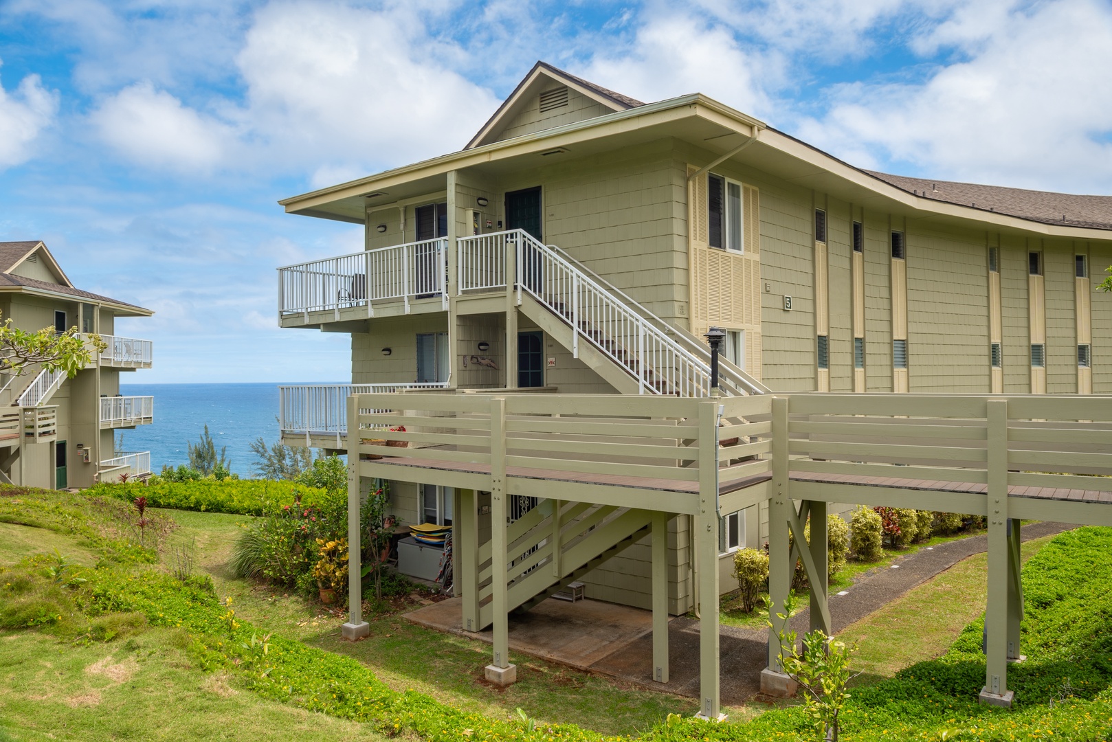 Princeville Vacation Rentals, Moana Kai - Home for the week: the top-floor corner, lifted above the bluff with the ocean behind it.