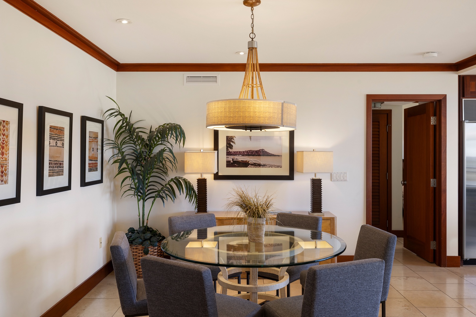 Kapolei Vacation Rentals, Ko Olina Beach Villas B403 - Gather around your elegant glass dining table where modern design meets warm wood accents for memorable meals together.