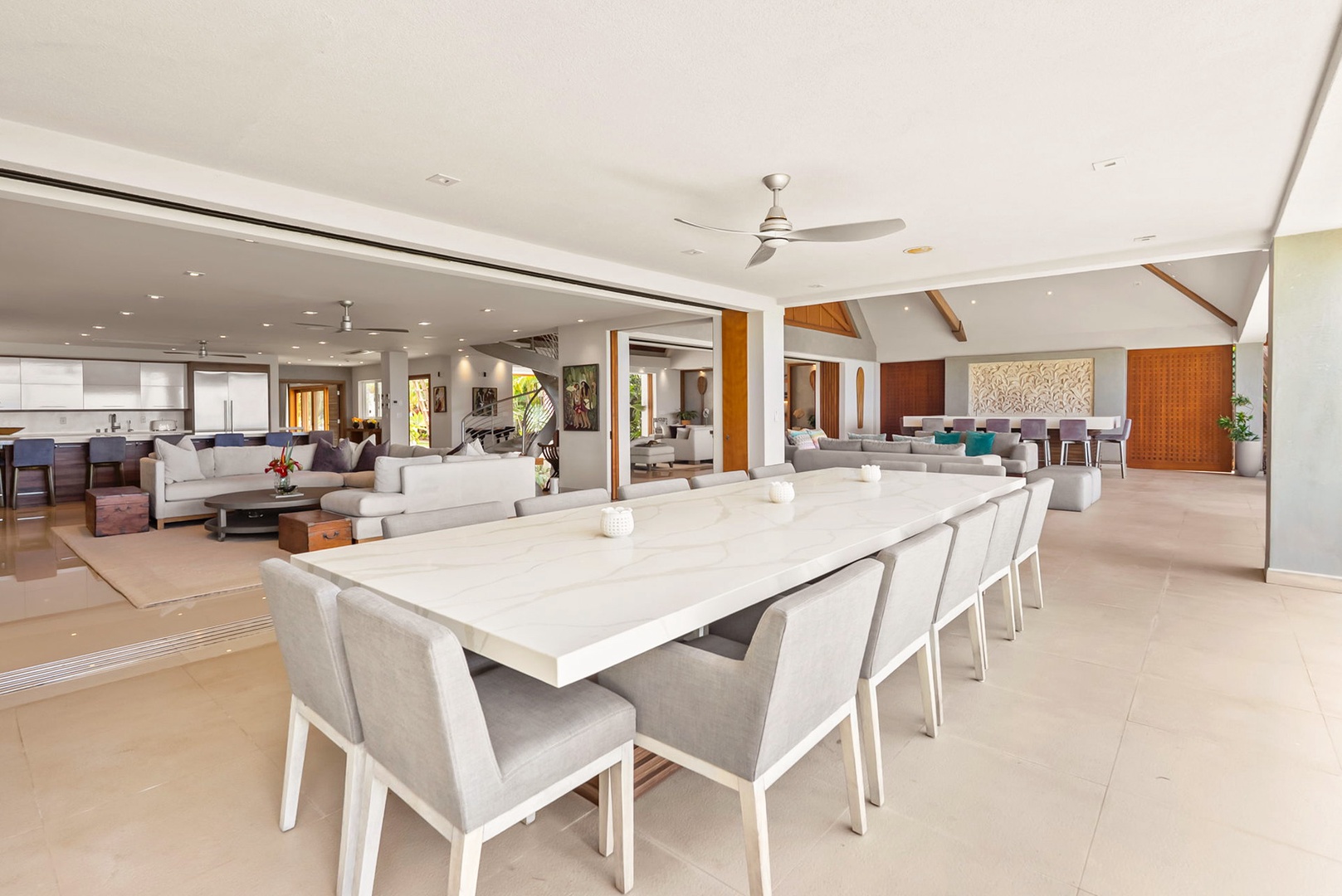 Honolulu Vacation Rentals, Diamond Head Beachfront Estate - Your open-concept gathering space flows seamlessly from dining to lounge, inviting you to entertain under soaring ceilings cooled by ceiling fans and brightened by natural light.