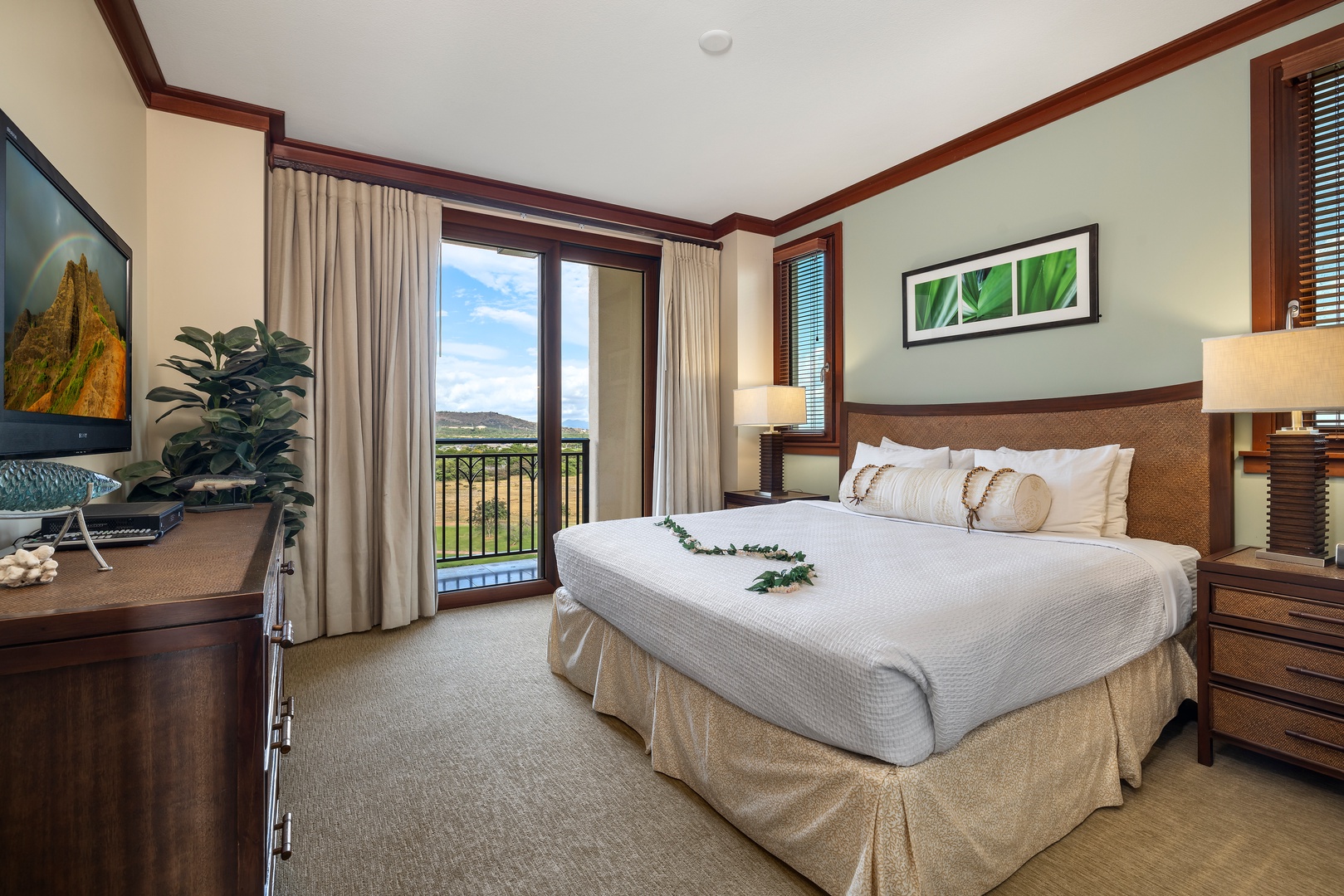 Kapolei Vacation Rentals, Ko Olina Beach Villas O1006 - The primary guest bedroom with TV and sliding doors to the lanai.