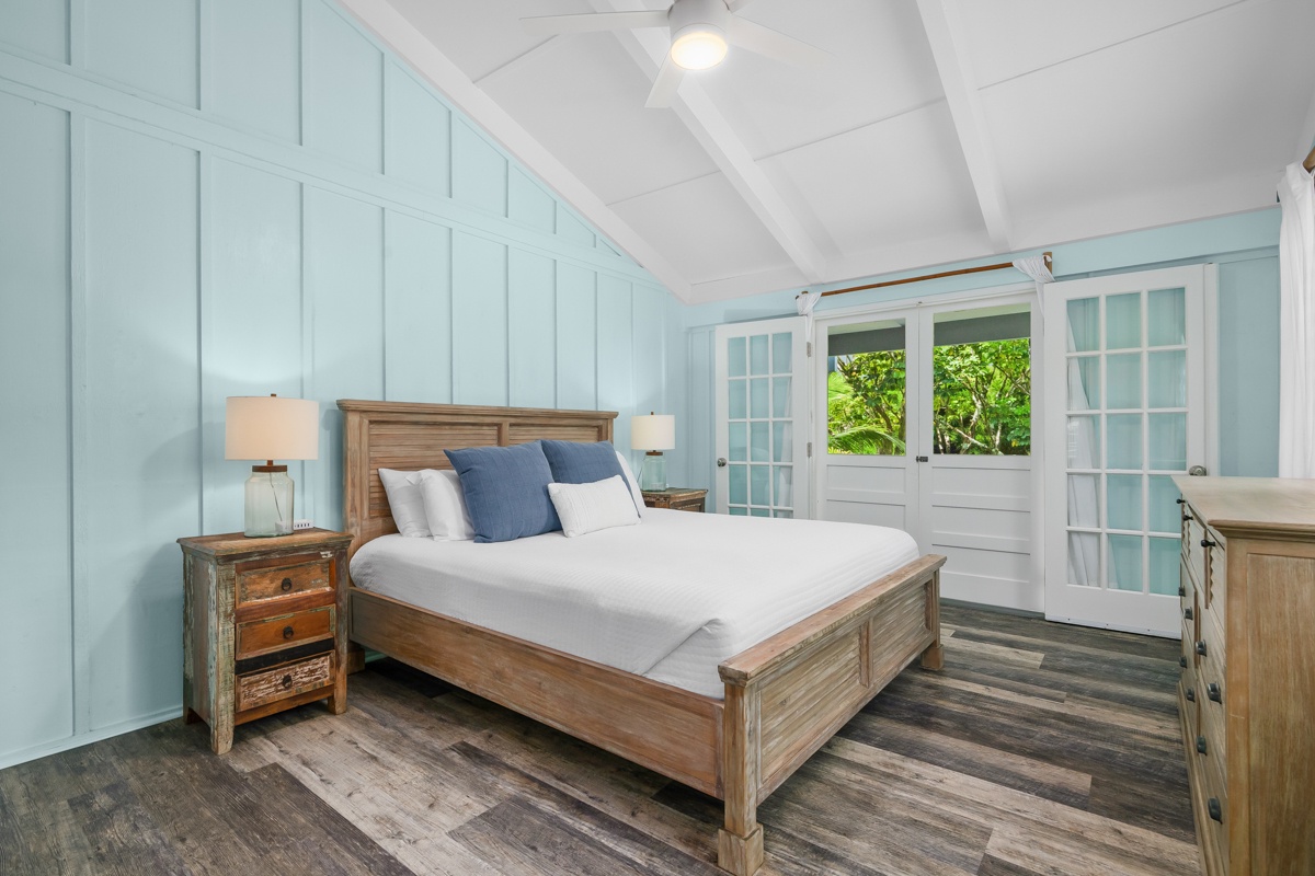Hanalei Vacation Rentals, Hale Kanani (Kaua'i) TVNC 1342 - From the doorway, the wood bed frame and greenery-framed window keep the room calm and cool.
