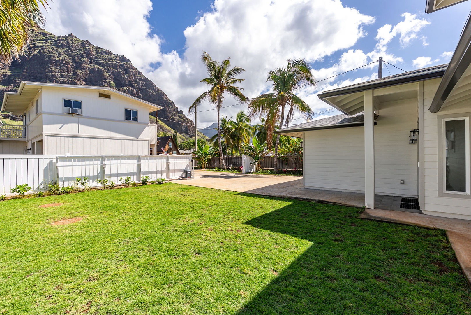 Waianae Vacation Rentals, Oceanfront Luxury Dream Estate - Rear lawn area offers privacy and lush green space—ideal for sunbathing, lawn games, or gardening.