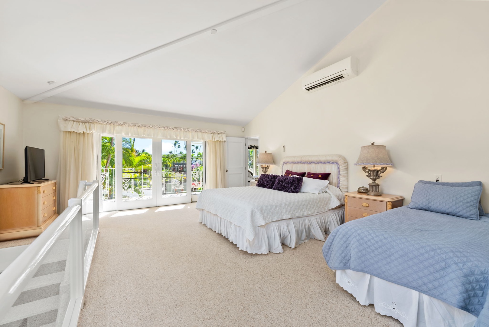 Honolulu Vacation Rentals, Kahala Oasis - Bright guest suite with sliding doors that open to a private balcony, offering beautiful garden views.