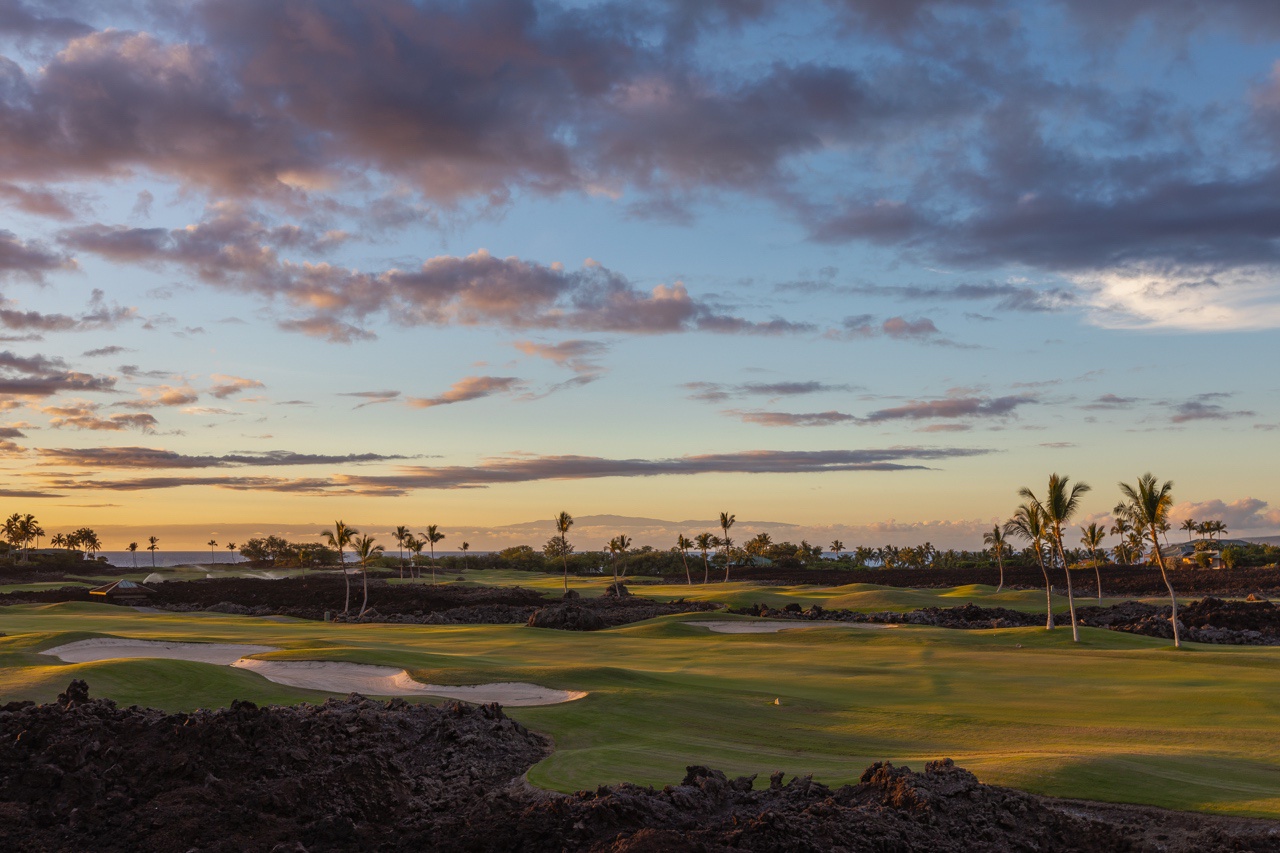 Waimea Vacation Rentals, 5BD Mauna Lani Lux Golf Estate (4) at One Ocean - This serene golf course view captures the essence of a tranquil evening, with lush fairways framed by volcanic rock under a spectacular sunset sky.