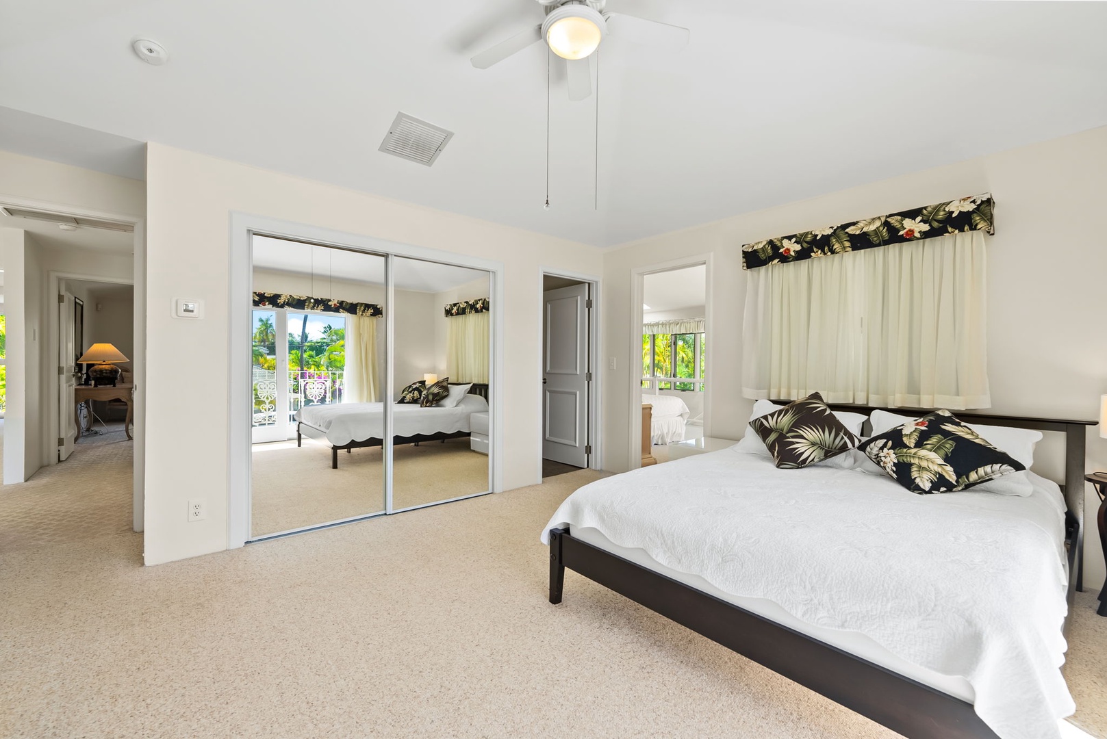 Honolulu Vacation Rentals, Kahala Oasis - Bright guest suite featuring a mirrored closet and large windows for a light and airy feel.