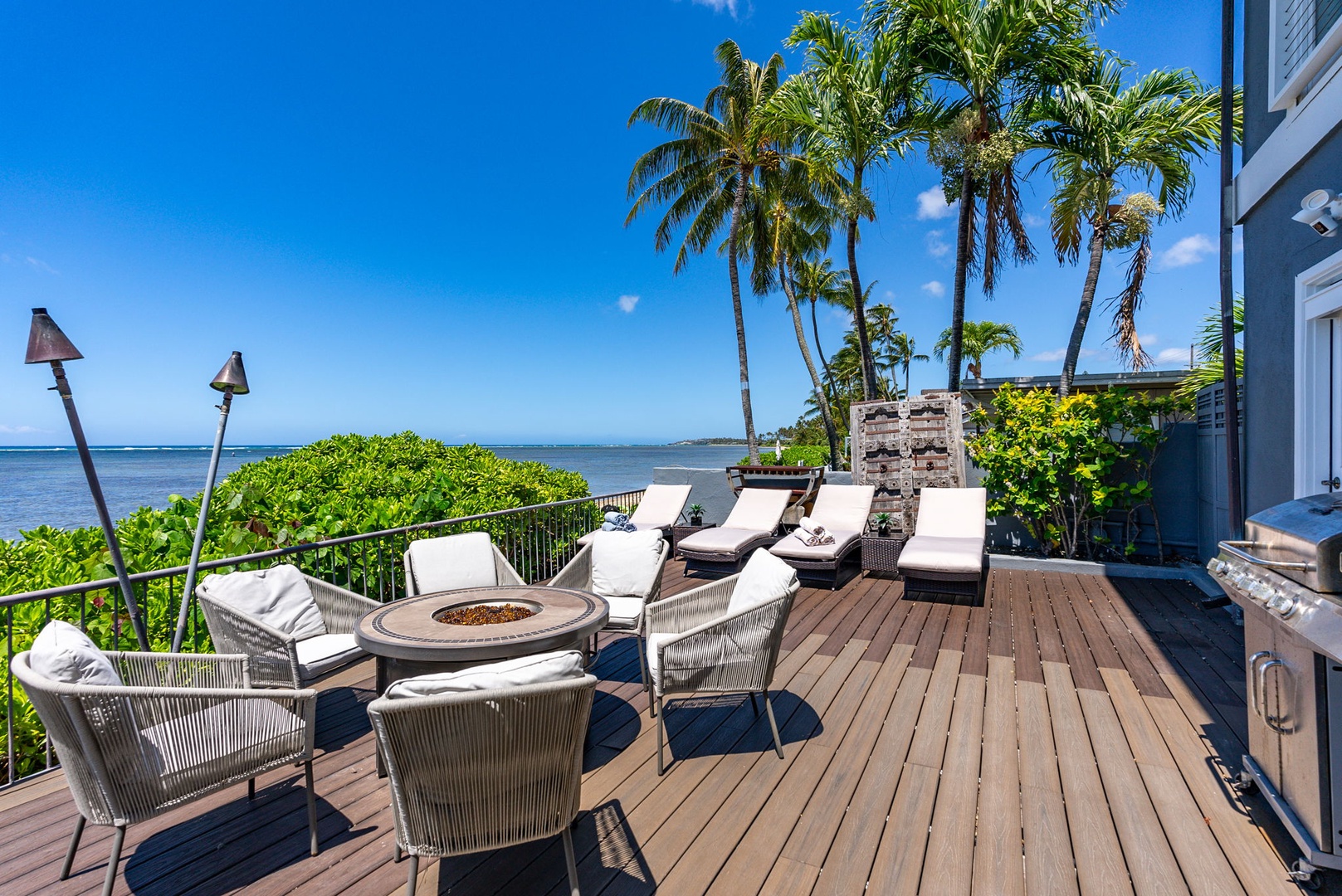 Honolulu Vacation Rentals, Wailupe Beachfront Getaway - Relax on the chaise loungers on the deck with BBQ grill.