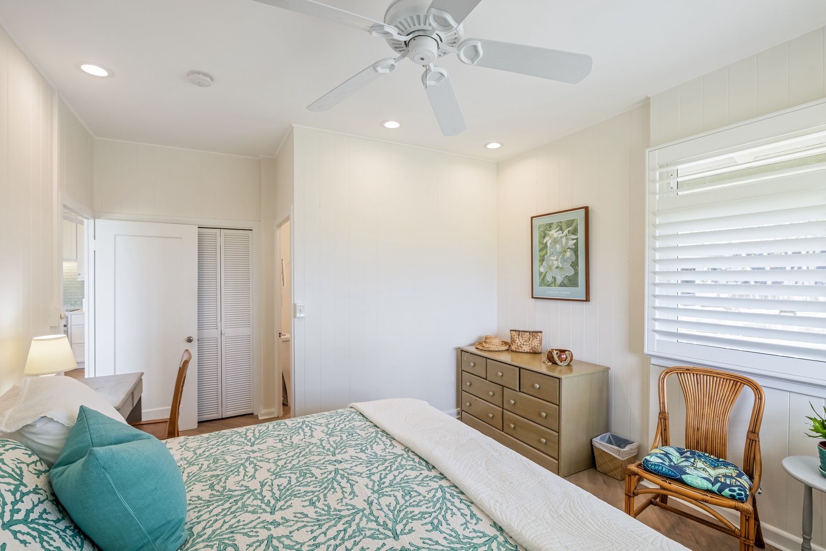 Kailua Vacation Rentals, Hale Moana Lanikai - This restful bedroom combines modern comfort with a touch of vintage charm, featuring a spacious bed with stylish, sea-inspired linens and a classic wooden dresser