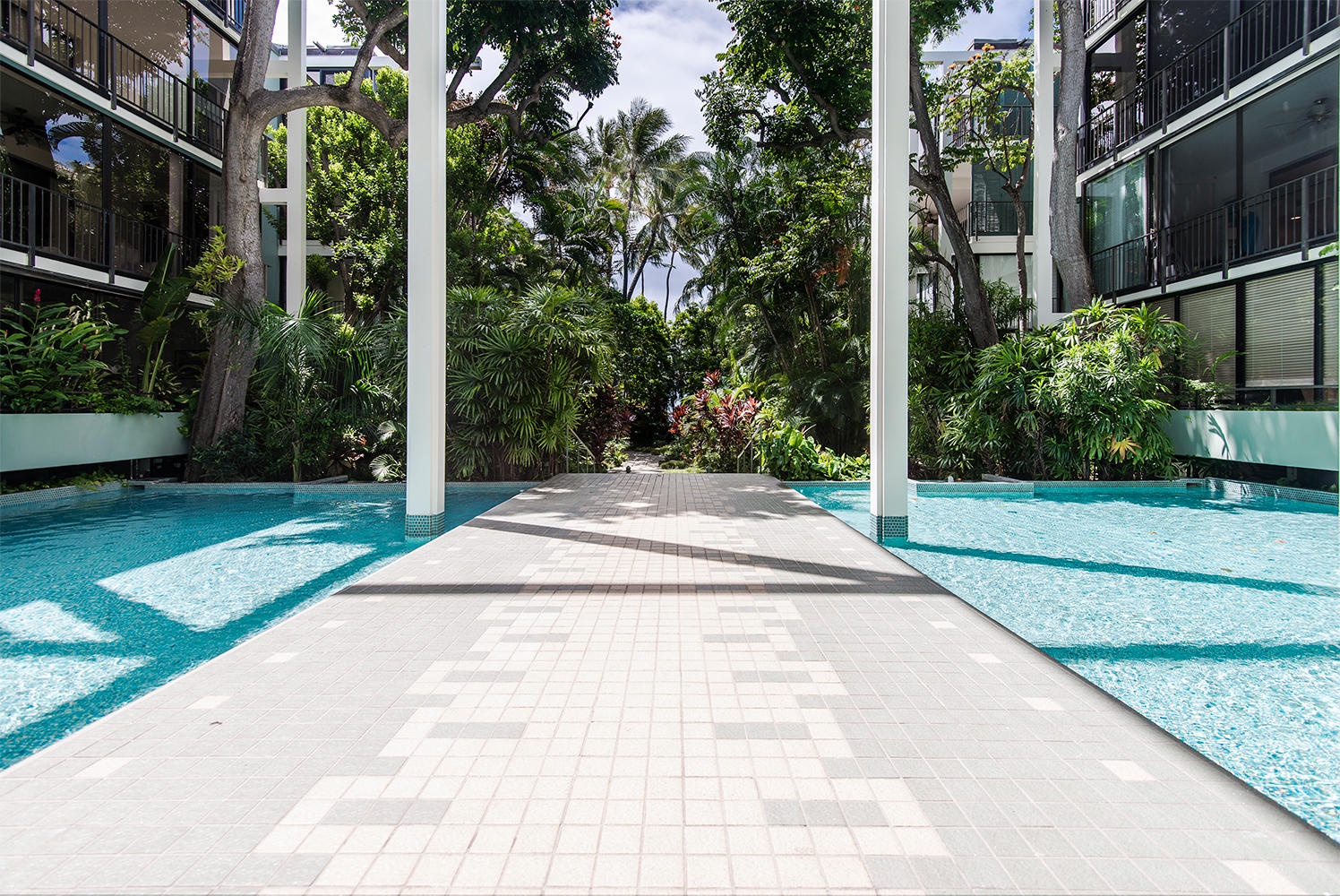 Honolulu Vacation Rentals, Kahala Beachfront Villa - Stroll around the community pool surrounded by lush foliage.