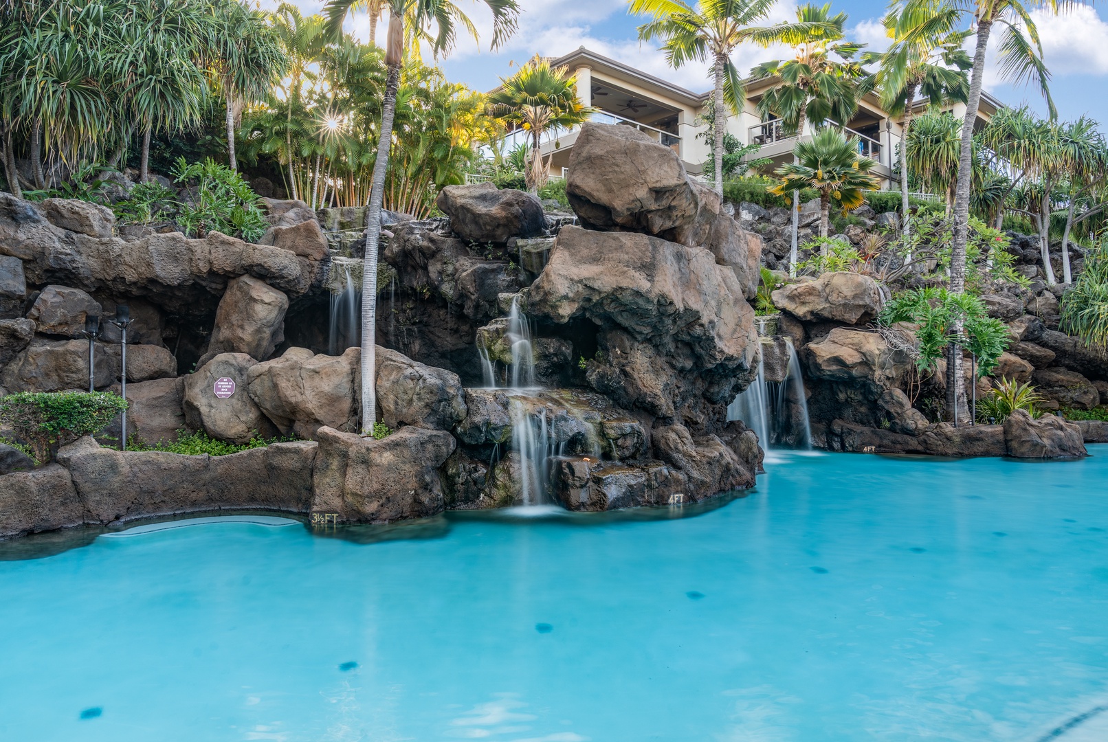 Wailea Vacation Rentals, Wailea Luxury Residence Hoolei 23-3 - Dive into the vibrant blue pool framed by a dramatic rock waterfall at Wailea Luxury Residence Hoolei 23-3.