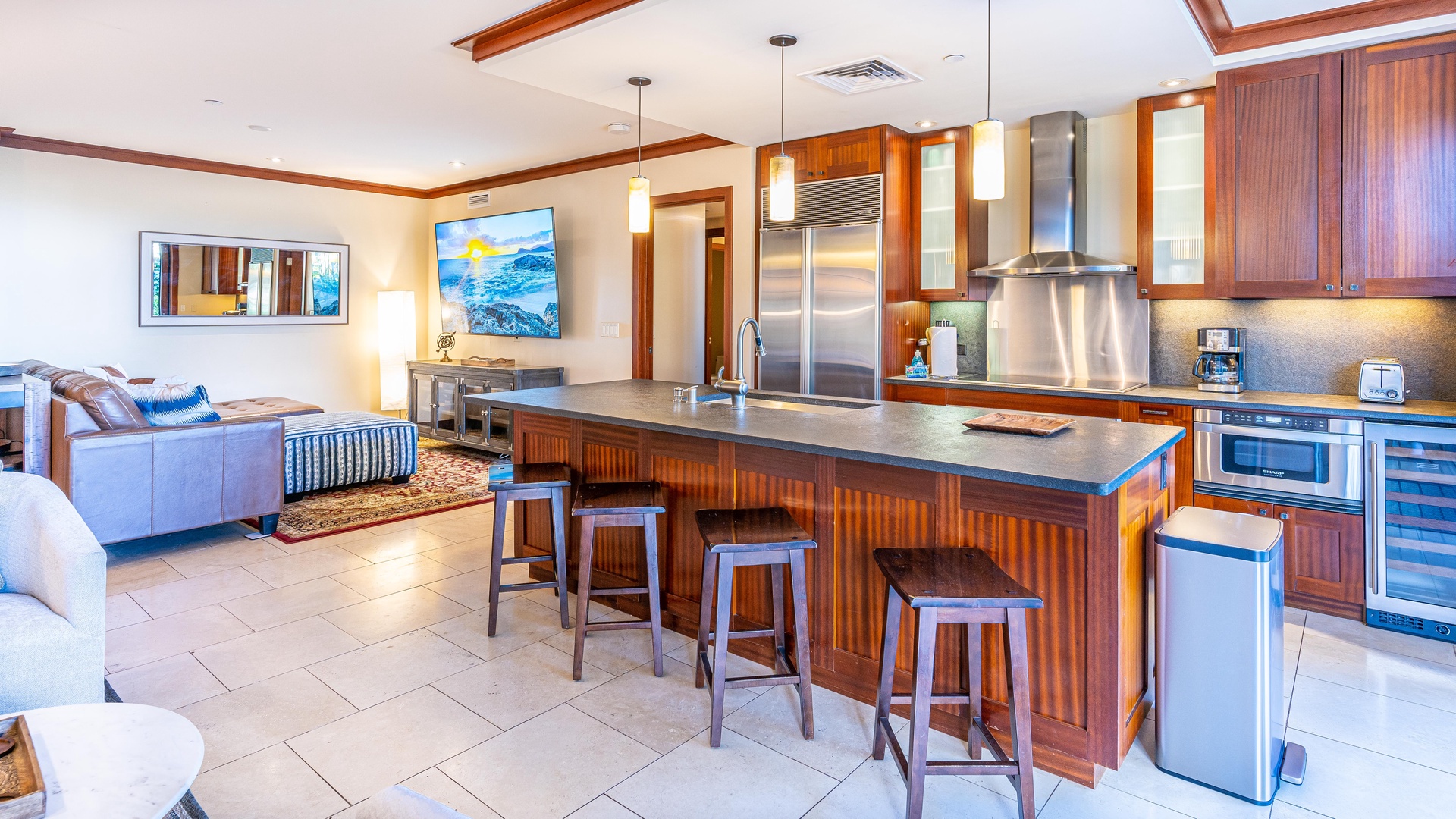 Kapolei Vacation Rentals, Ko Olina Beach Villas B102 - This Ko Olina Oahu kitchen has a Roy Yamaguci design with a wine fridge and bar seating.