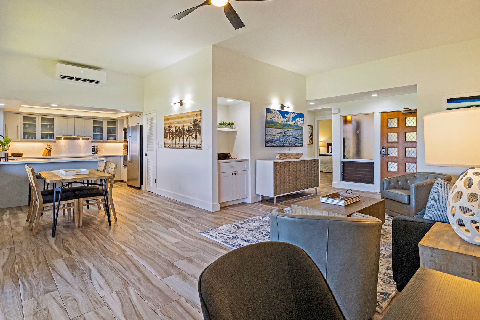 Lahaina Vacation Rentals, Kapalua Ridge 1421 - The open-concept living area provides a seamless flow between the kitchen, dining, and entry spaces, with modern finishes and warm natural lighting