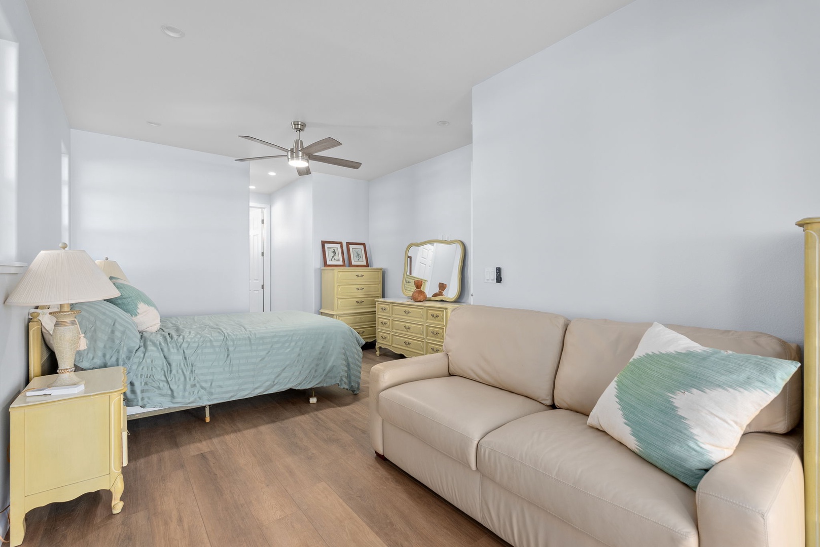 Waianae Vacation Rentals, Oceanfront Luxury Dream Estate - Suite layout includes plush bedding, ceiling fan, and a cozy reading nook with direct outdoor access.