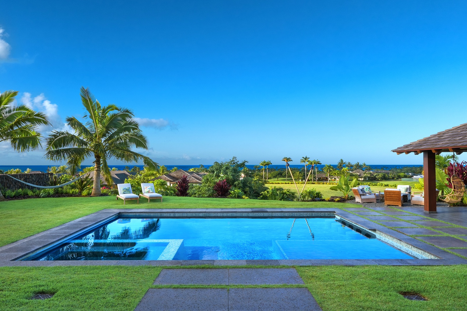 Koloa Vacation Rentals, Hale Ka Pua Ola at Kukuiula - Dive into relaxation with the sparkling pool surrounded by lush greenery.