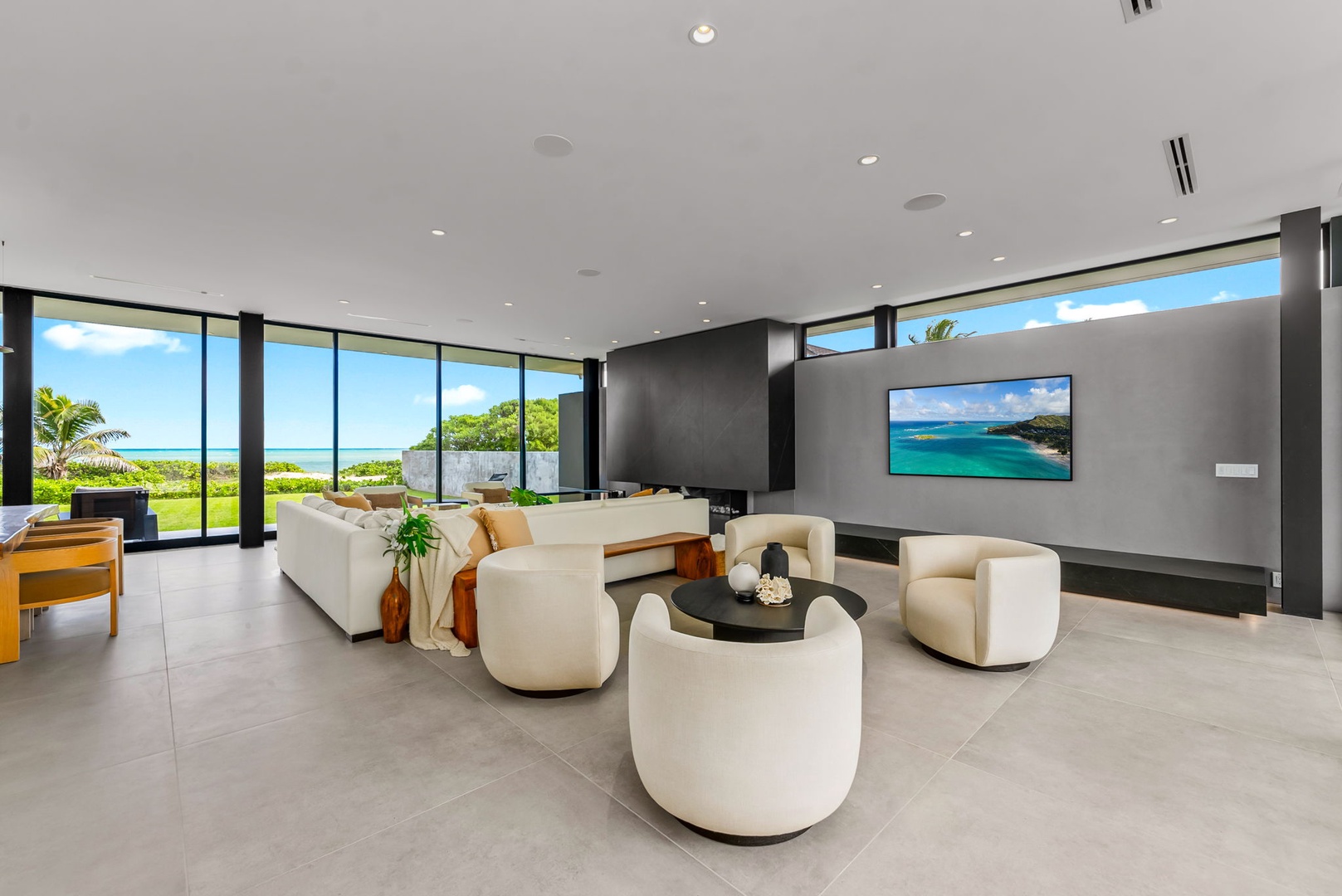 Kailua Vacation Rentals, Kailua Beach Escape - Unwind in a bright gathering space where floor-to-ceiling glass frames the ocean beyond.