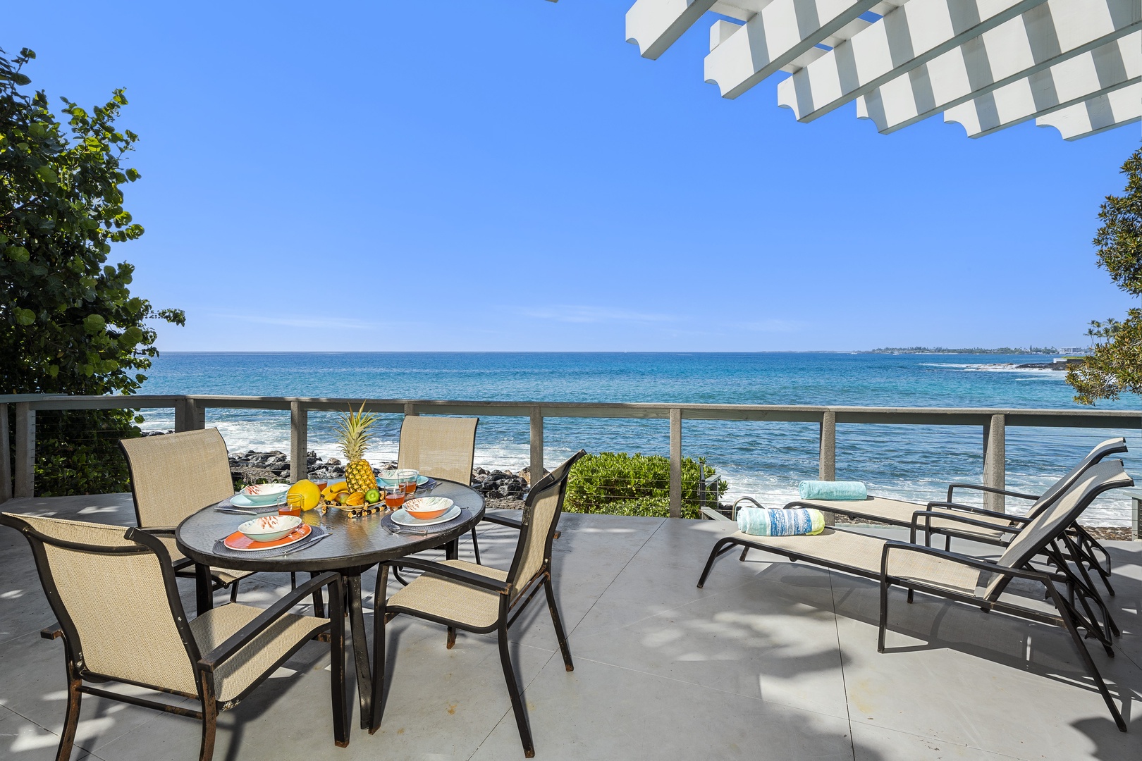 Kailua-Kona Vacation Rentals, Hale Kope Kai - Oceanfront lanai with dining and lounge seating—ideal for morning coffee or sunset meals.