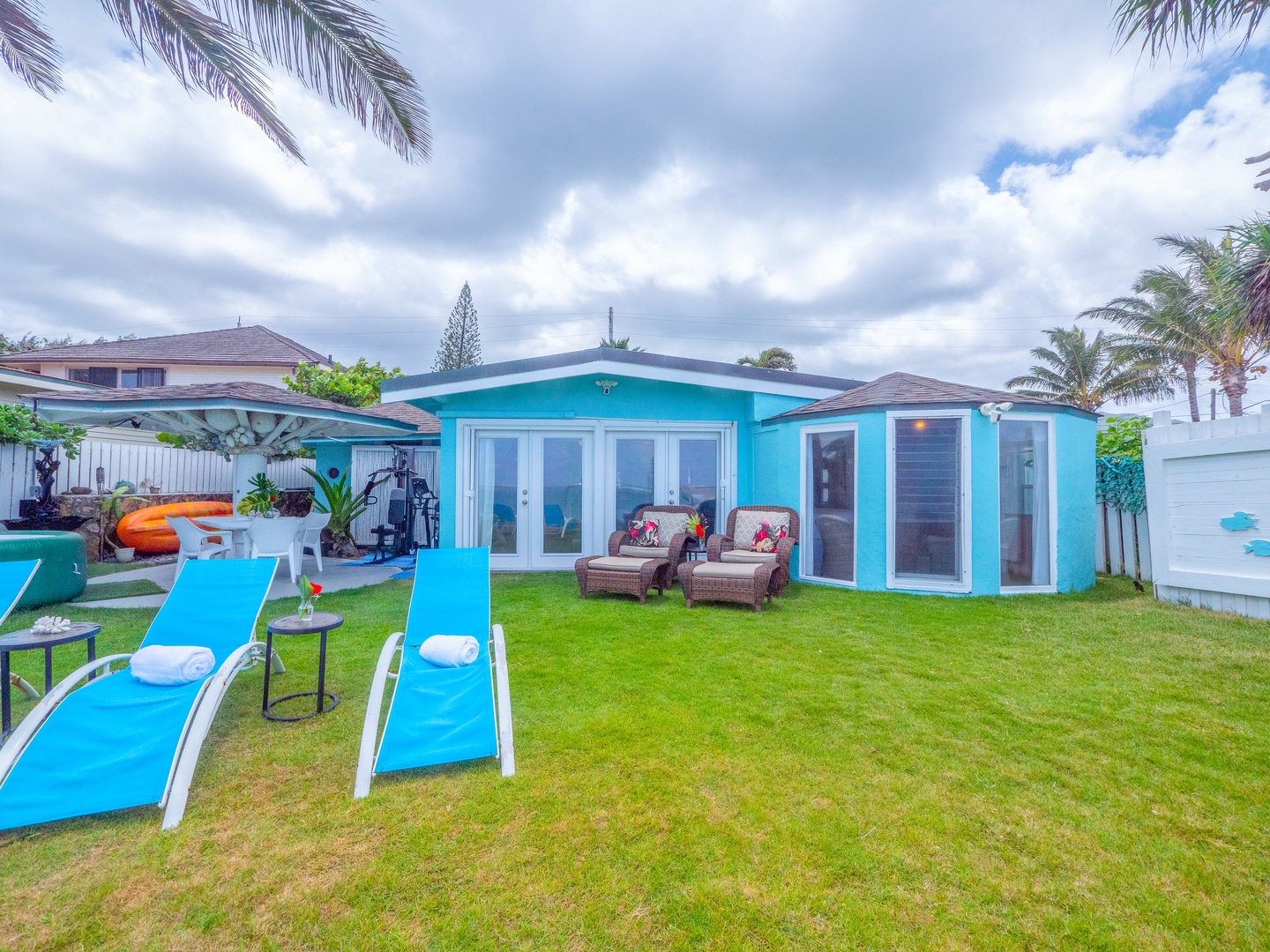 Hauula Vacation Rentals, Private Beach Paradise - Your tranquil North Shore retreat unfolds across a wide grassy yard framed by the ocean—perfect for morning coffee, family playtime, or watching the light shift across turquoise waters.