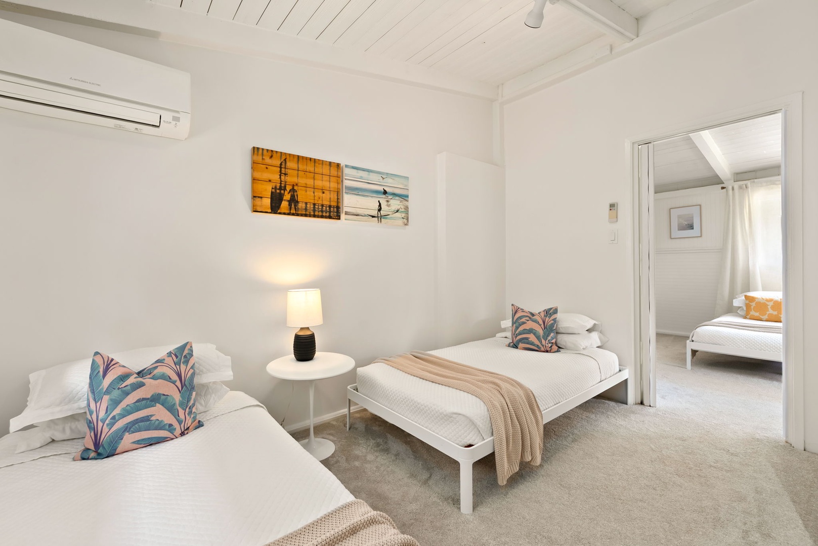 Honolulu Vacation Rentals, Ho'okipa Villa - Sink into crisp white linens and let coastal artwork transport you. Two comfy beds ensure everyone sleeps soundly while the nearby bedroom offers even more space to spread out.