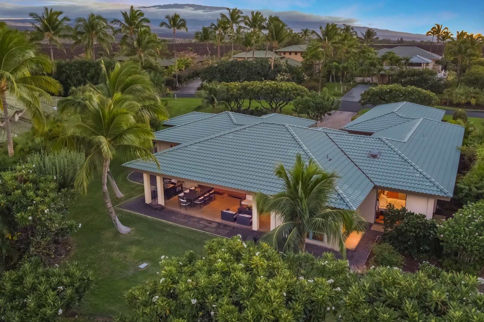 Kamuela Vacation Rentals, Champion Ridge Oasis - Aerial view of the immaculate property, showcasing the main lanai surrounded by lush tropical greenery and privacy.