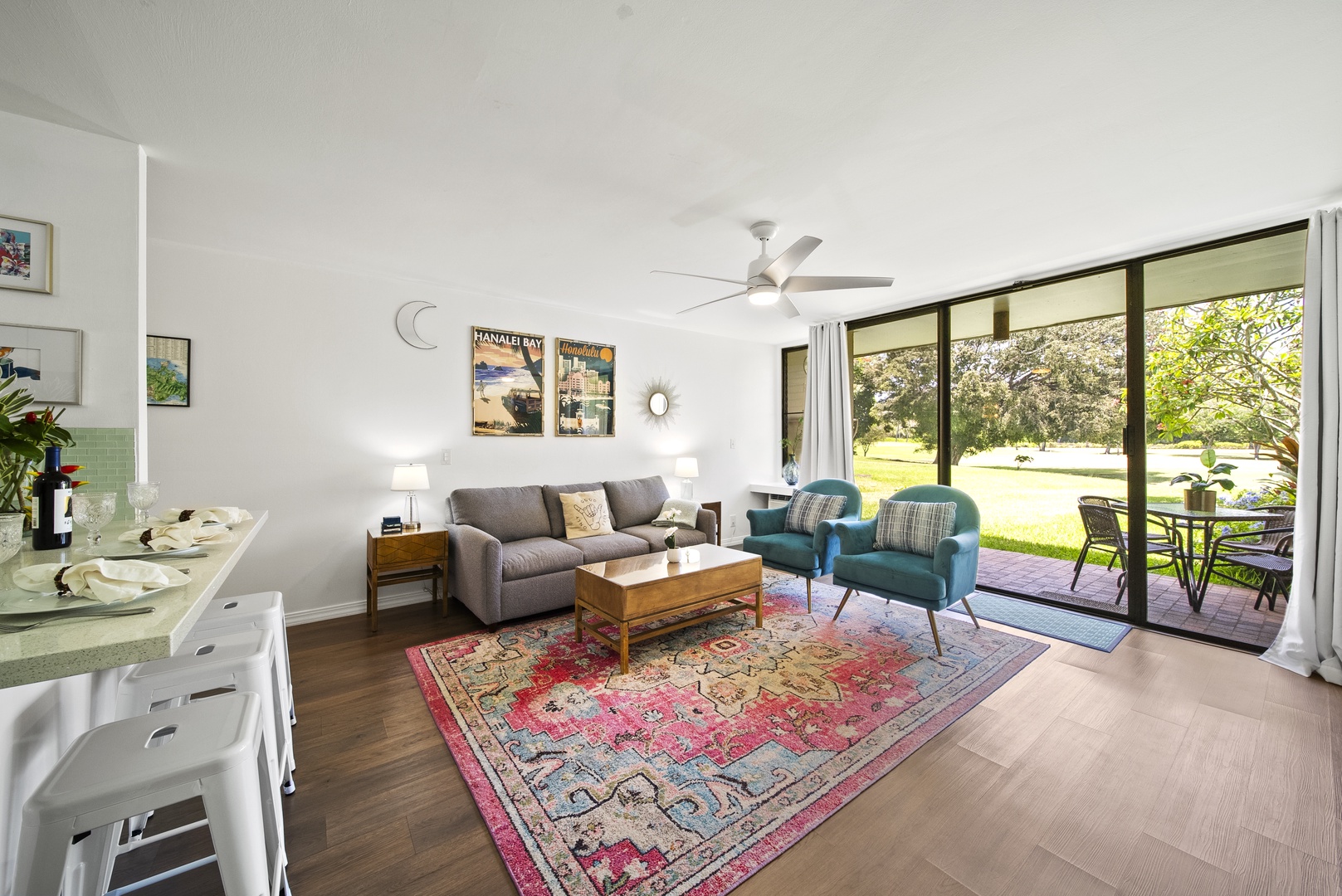 Kahuku Vacation Rentals, Pulelehua Kuilima Estates West #142 - Main living area with queen sleeper sofa looking to the lanai.