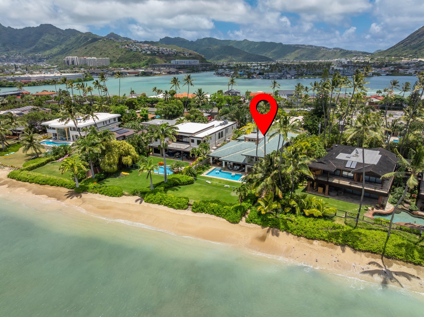 Honolulu Vacation Rentals, Maunalua Estate - Aerial views capture the home's rare stretch of sandy beachfront and calm turquoise waters.