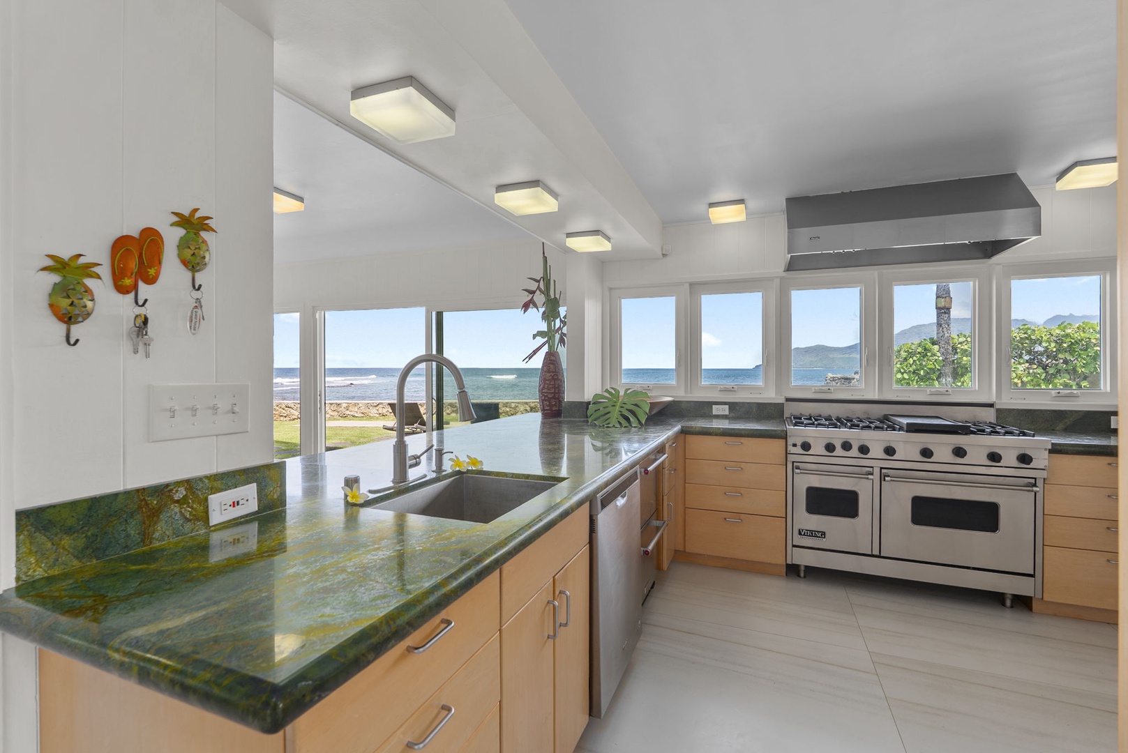 Waianae Vacation Rentals, Ma'ili Blue - Prep meals with stunning ocean views as your backdrop in this bright, modern kitchen featuring premium appliances and vibrant countertops.