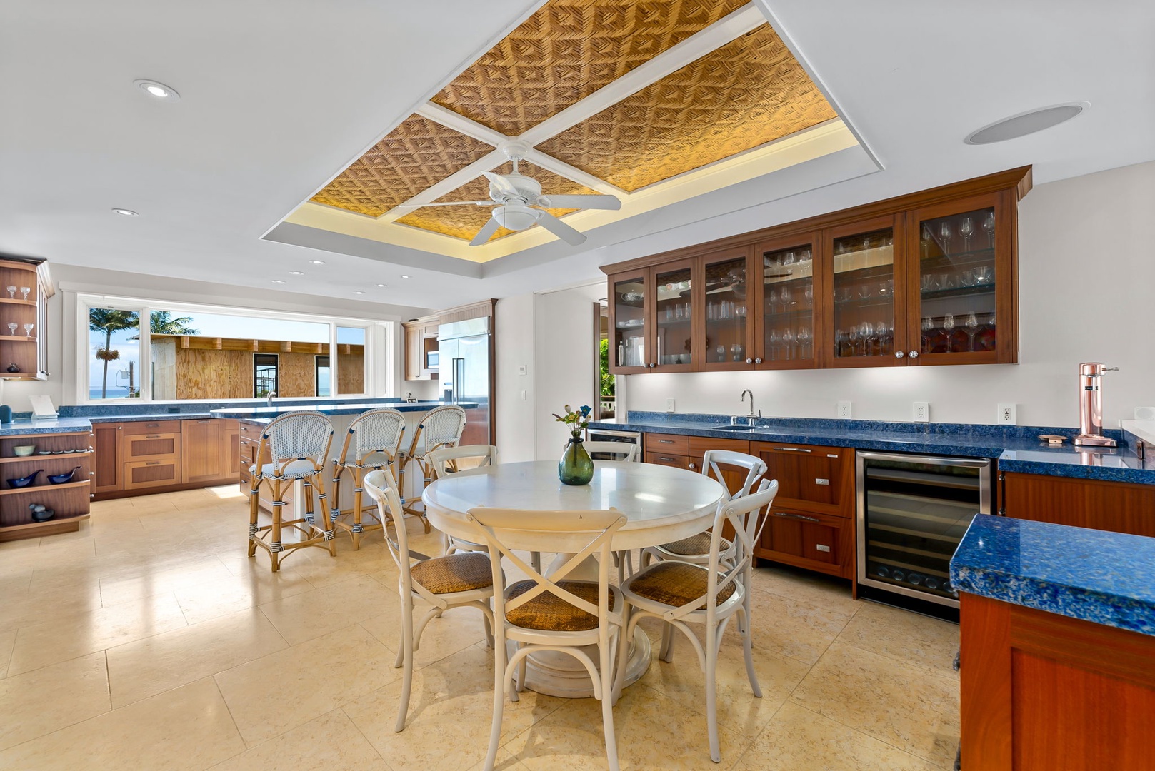 Kailua Vacation Rentals, Leaf House - Imagine gathering around this elegant dining table in your spacious gourmet kitchen, with rich wood cabinetry, gleaming blue granite counters, and stunning tray ceiling accents creating a warm, inviting space for your meals.