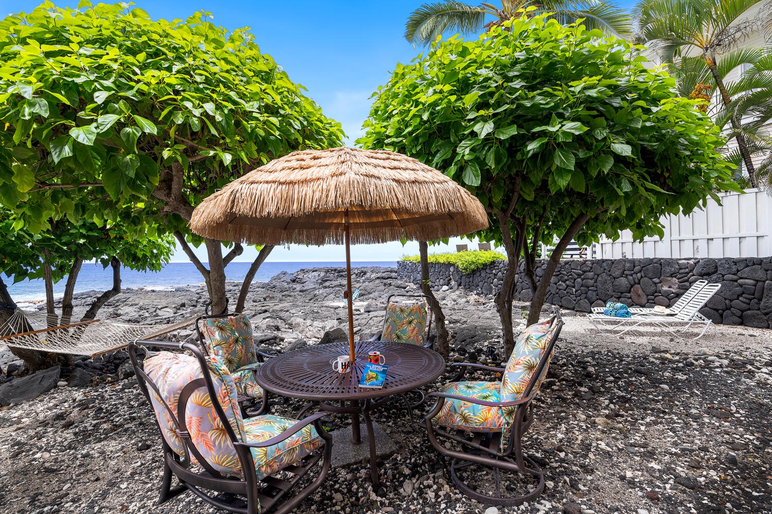 Kailua Kona Vacation Rentals, Kailani Vista - Claim this thatched table for morning malasadas or sunset charcuterie with the Pacific lapping at your feet—no reservation required.