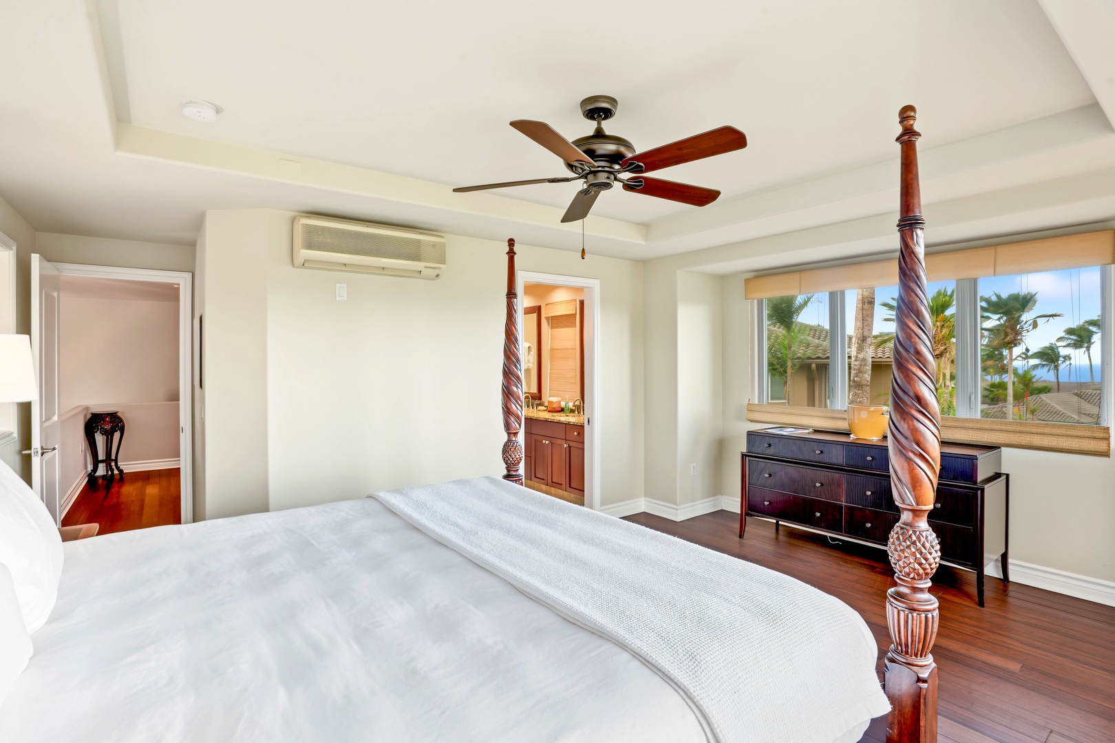 Princeville Vacation Rentals, Hale Hau'oli Moku - Settle into the carved four-poster cal king, with the ensuite just through the far doorway.