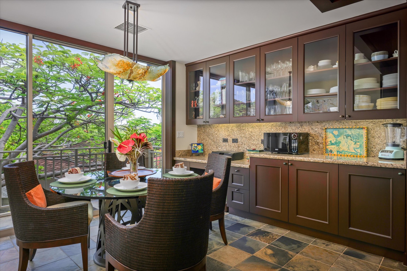Kailua Kona Vacation Rentals, Wai'ulu Villa 115D - Casual dining space surrounded by windows and greenery—ideal for laid-back meals or coffee breaks.