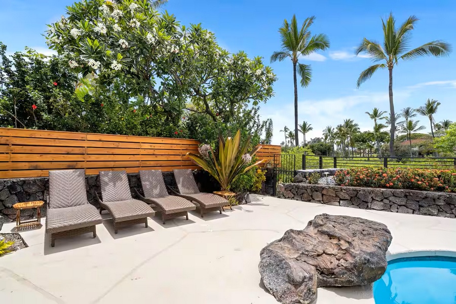 Kailua Kona Vacation Rentals, Manukai Hale - Loungers face the water along the pool's sunny edge.