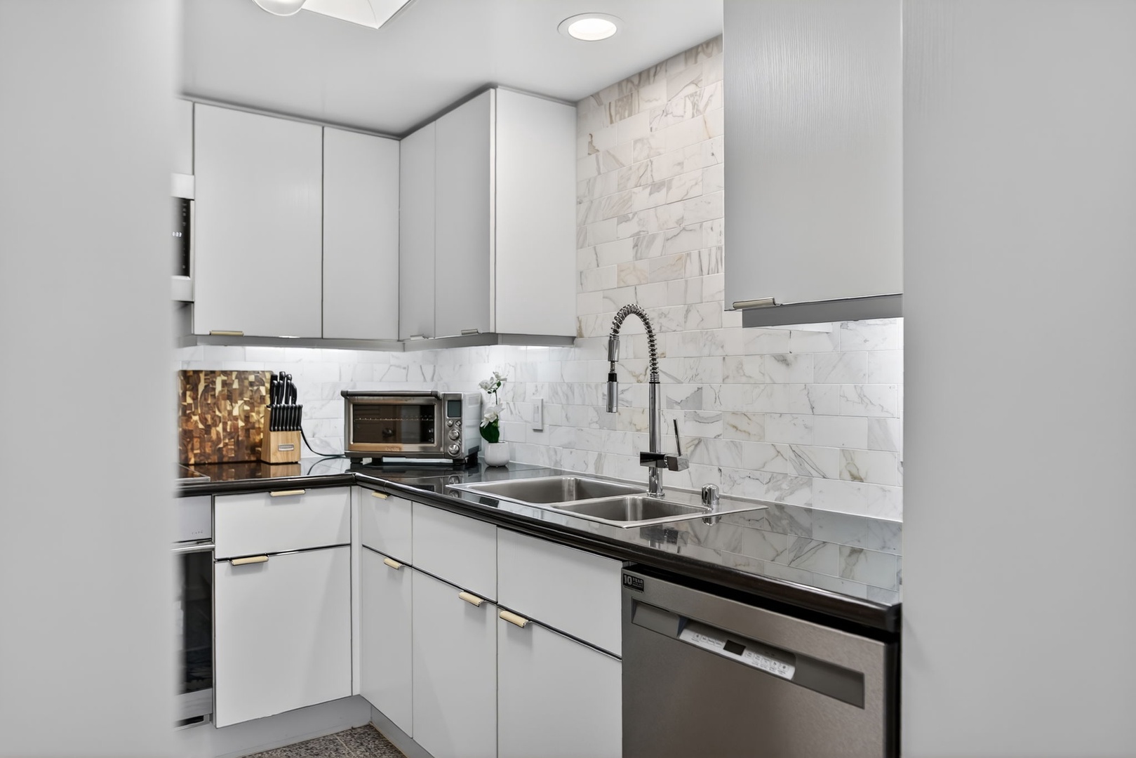 Honolulu Vacation Rentals, Island View at Waikiki Landmark - Cook comfortably in this modern kitchen with marble backsplash and stainless appliances.