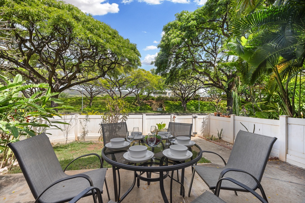 Dine al fresco on your private ground-level lanai, surrounded by lush tropical greenery and peaceful garden views.